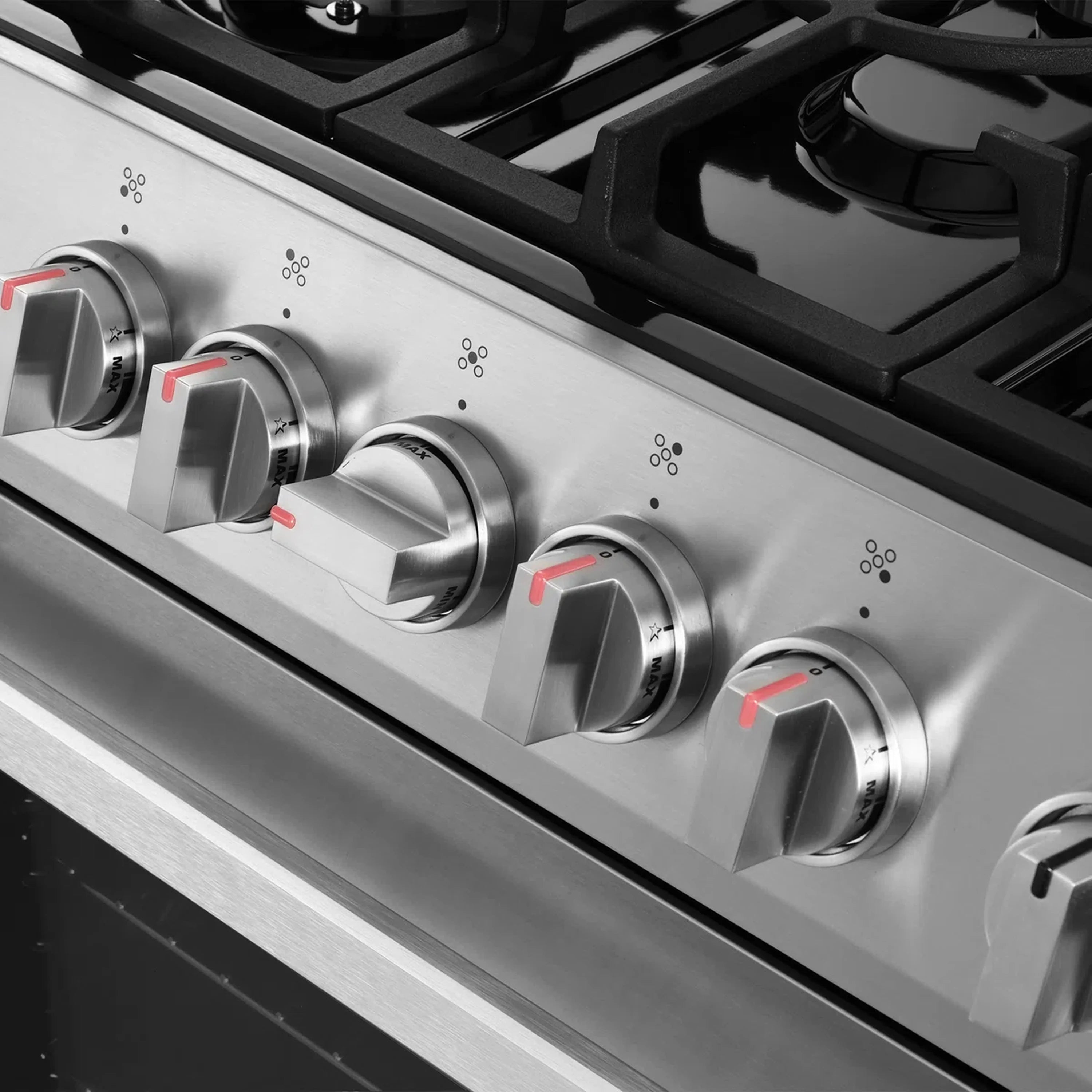 Stainless steel gas range front panel with multiple burner knobs and ignition markings