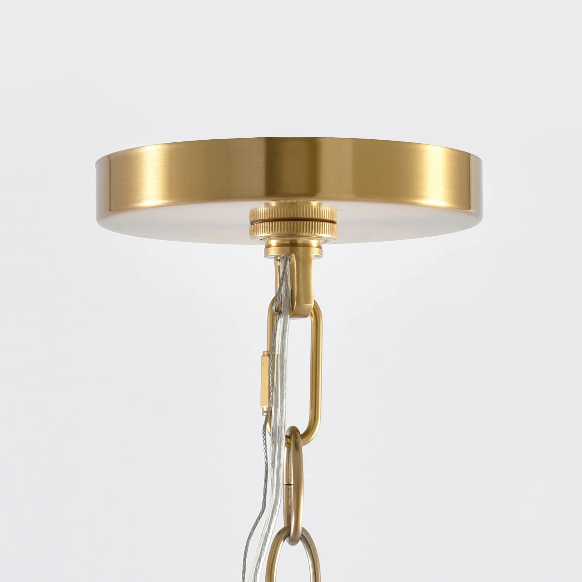 Golden round ceiling canopy with chain and clear hanging bulb fixture