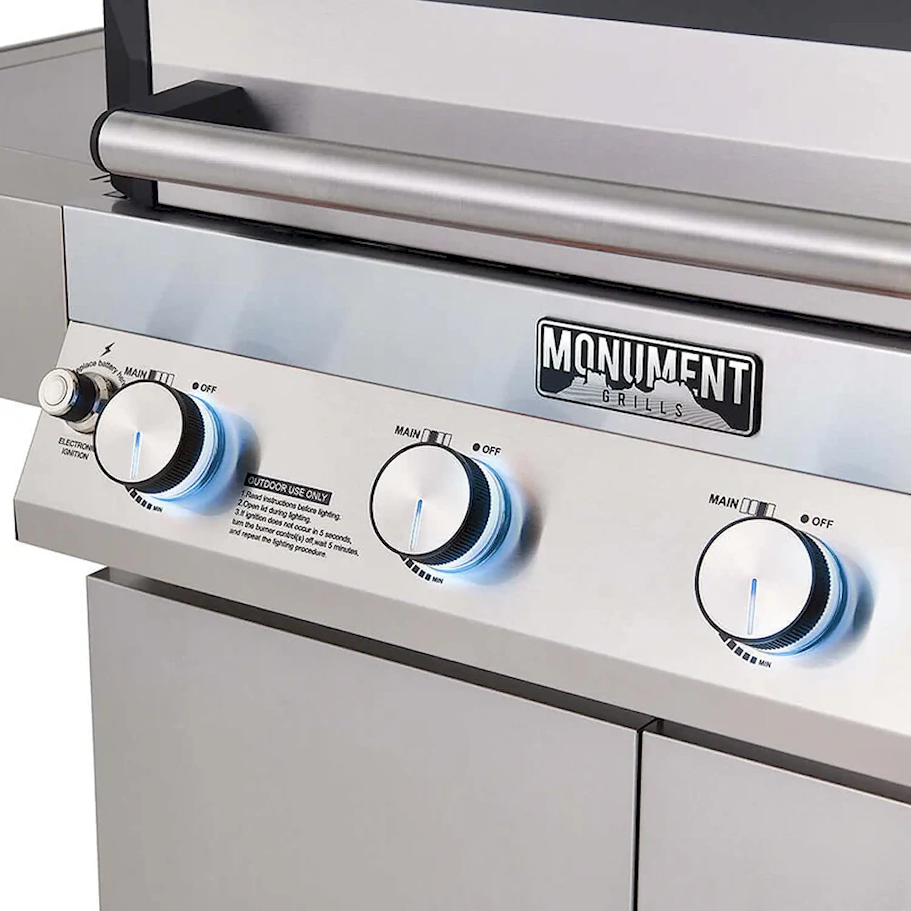 Stainless steel propane grill controls with lit indicator rings on burner knobs