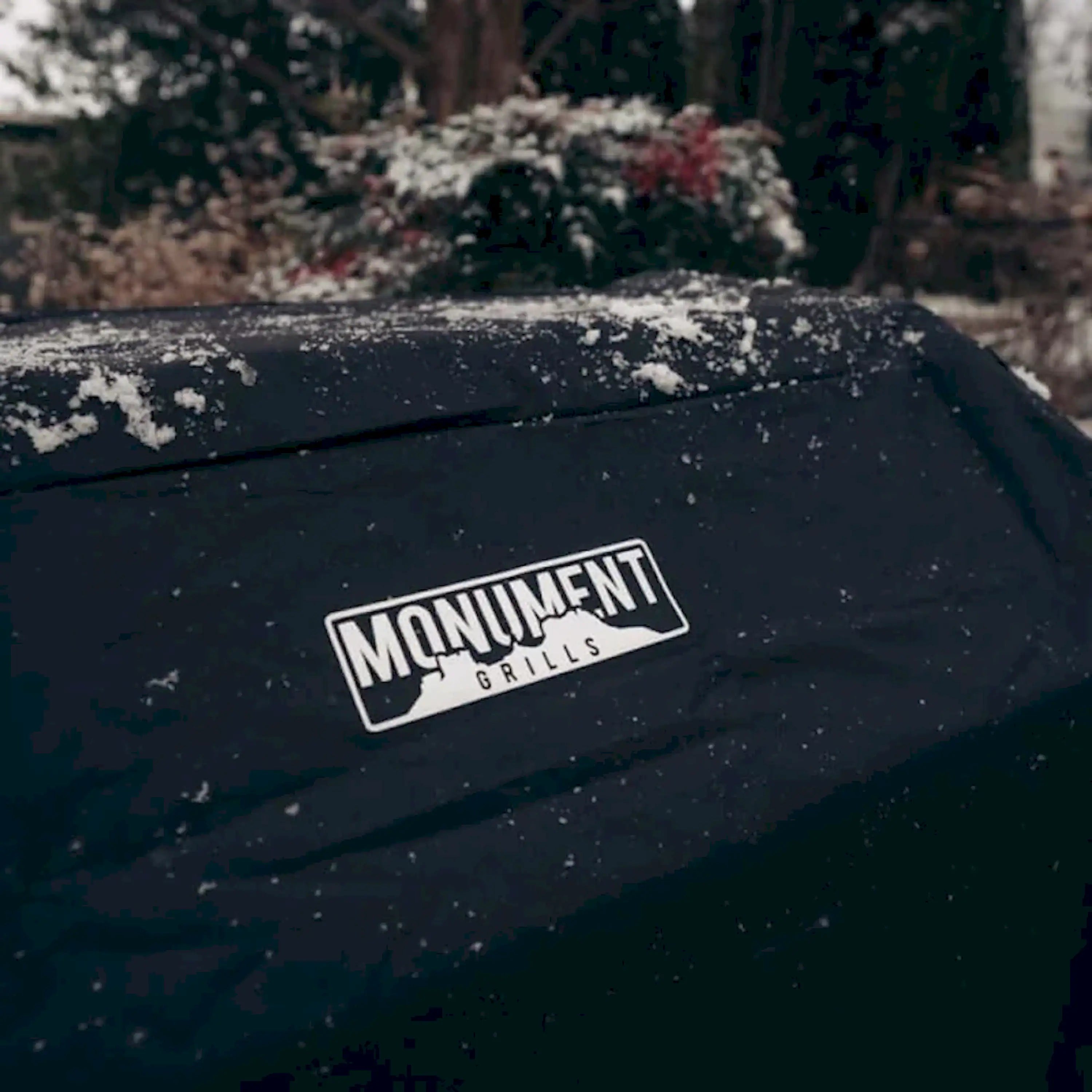 Protective grill cover with MONUMENT GRILLS logo on the top panel