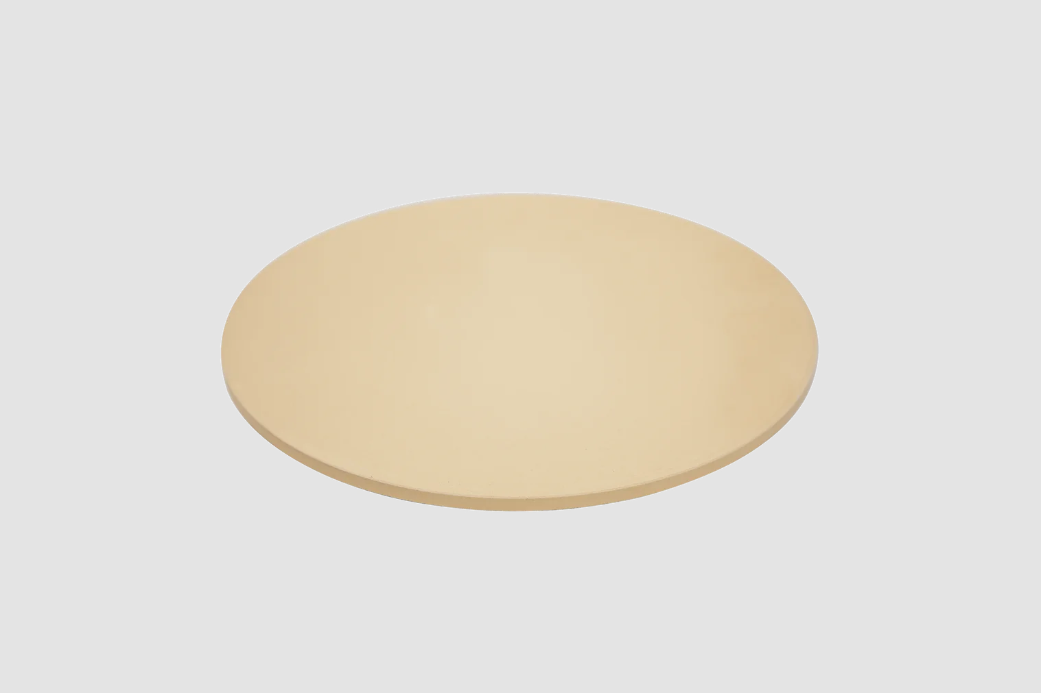 Round cordierite pizza stone, pale tan disc with smooth surface
