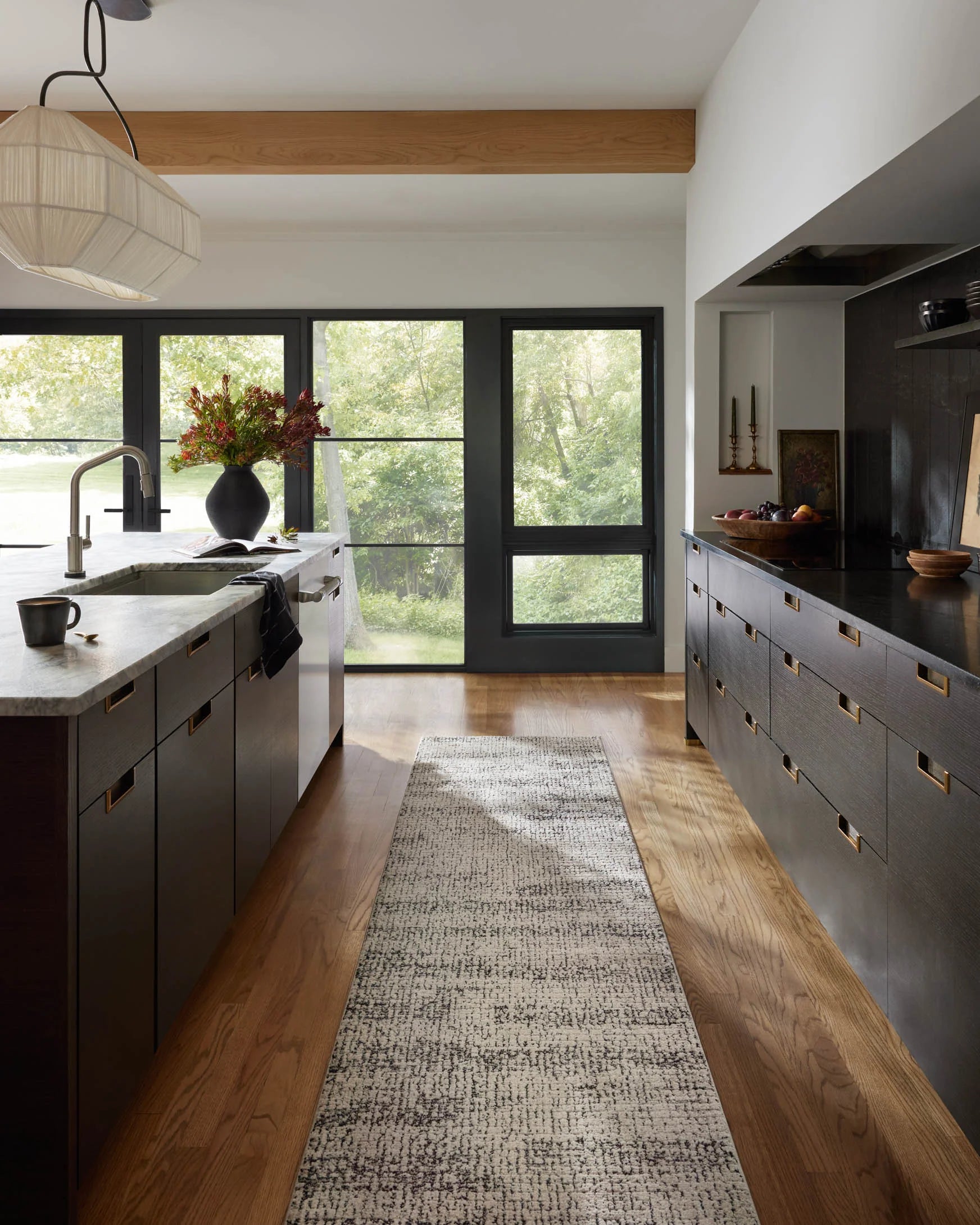 Oatmeal and charcoal runner rug laid on hardwood floor