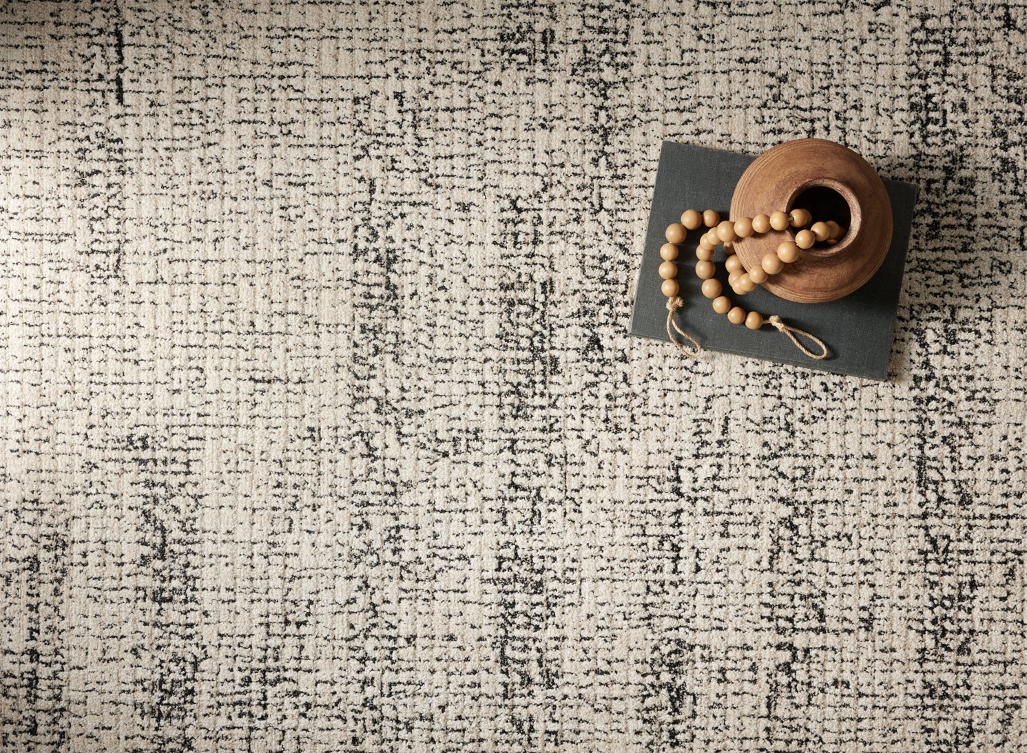 Oatmeal and charcoal rug surface detail with distressed vertical texture pattern