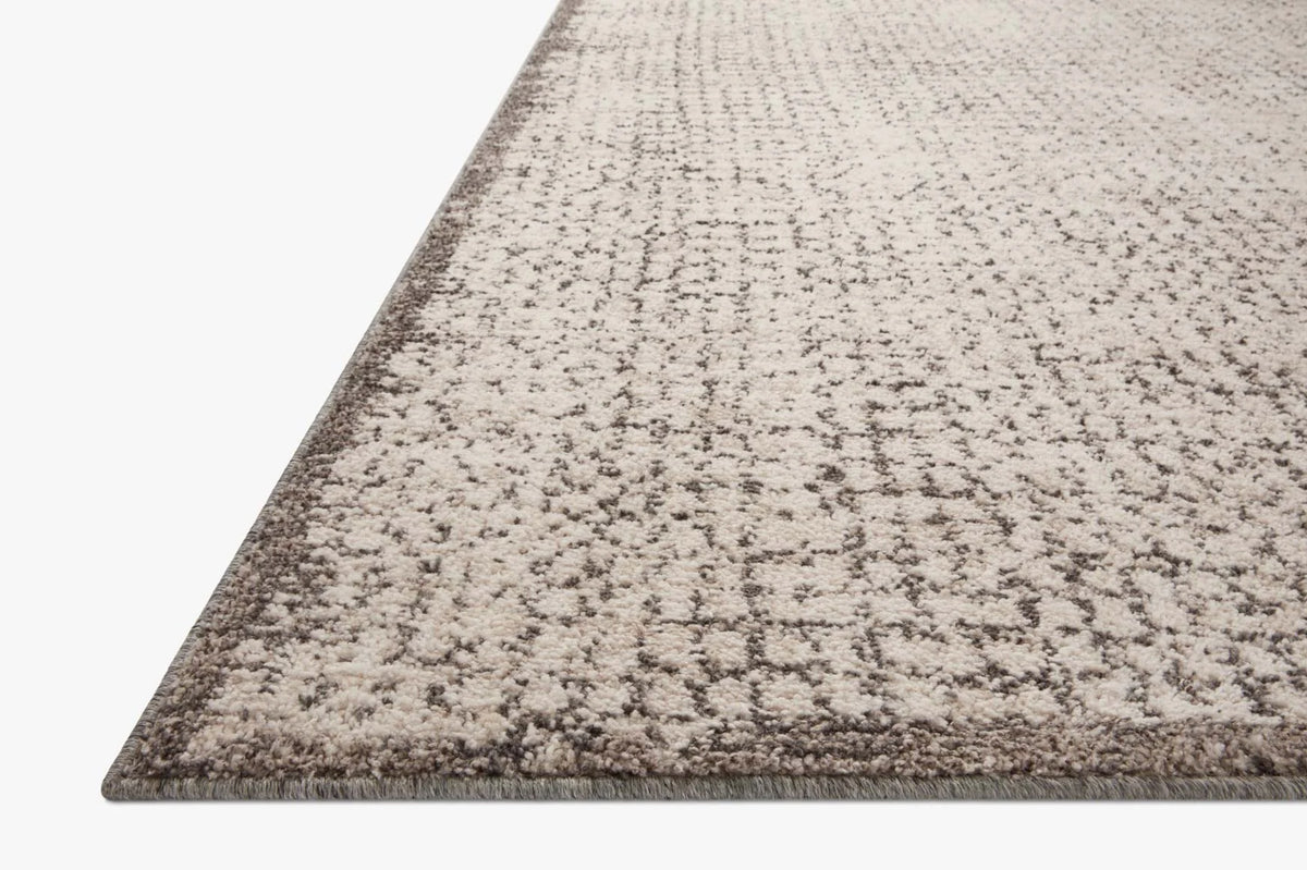Loloi II area rug in ivory and stone with distressed abstract pattern, textured pile edge