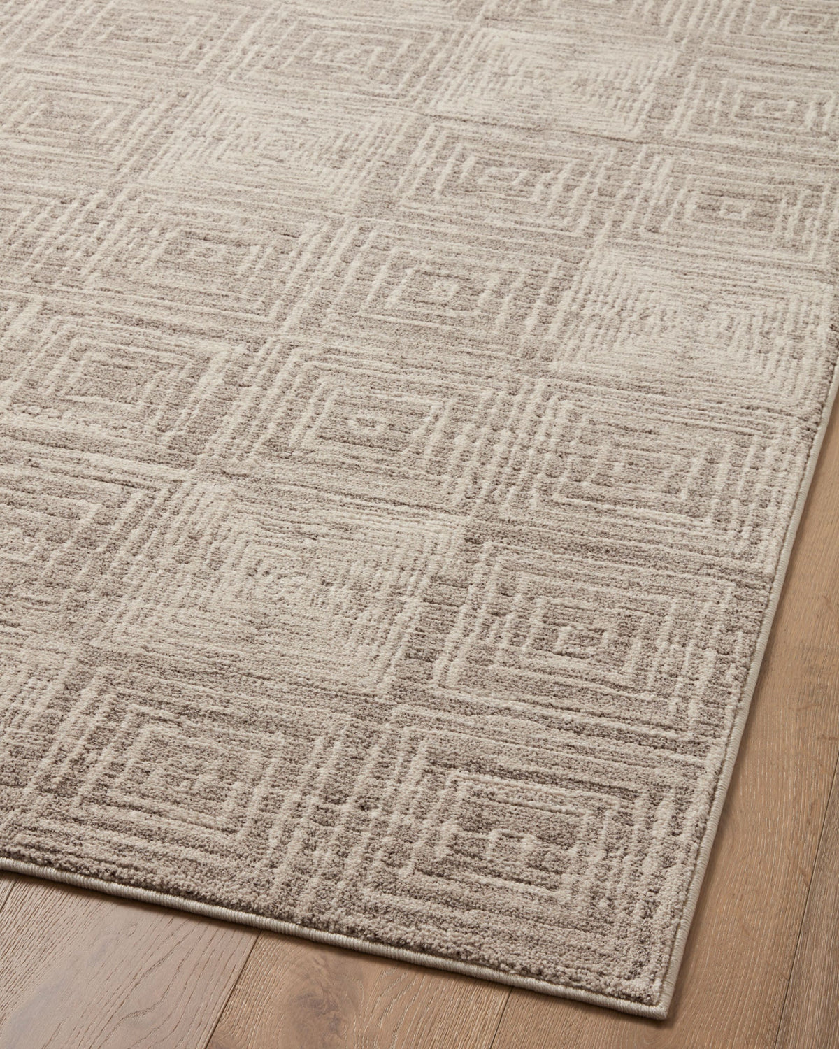 Beige and gray geometric runner rug showing repeating square motif and textured surface