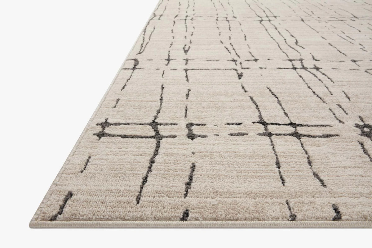 Sand area rug with dark gray crosshatch geometric lines and flat woven texture