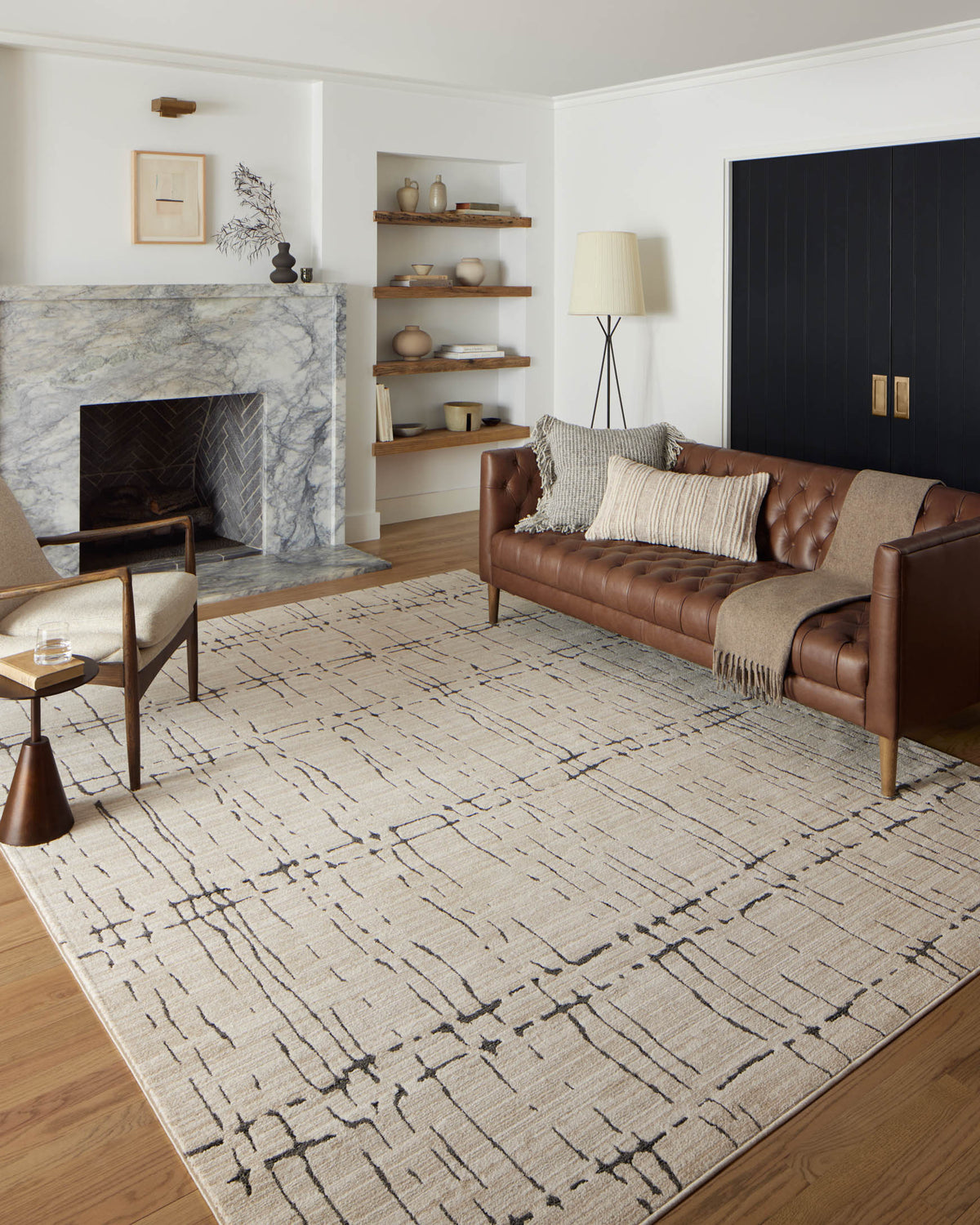 Beige area rug with dark gray geometric lines pattern in living room setting