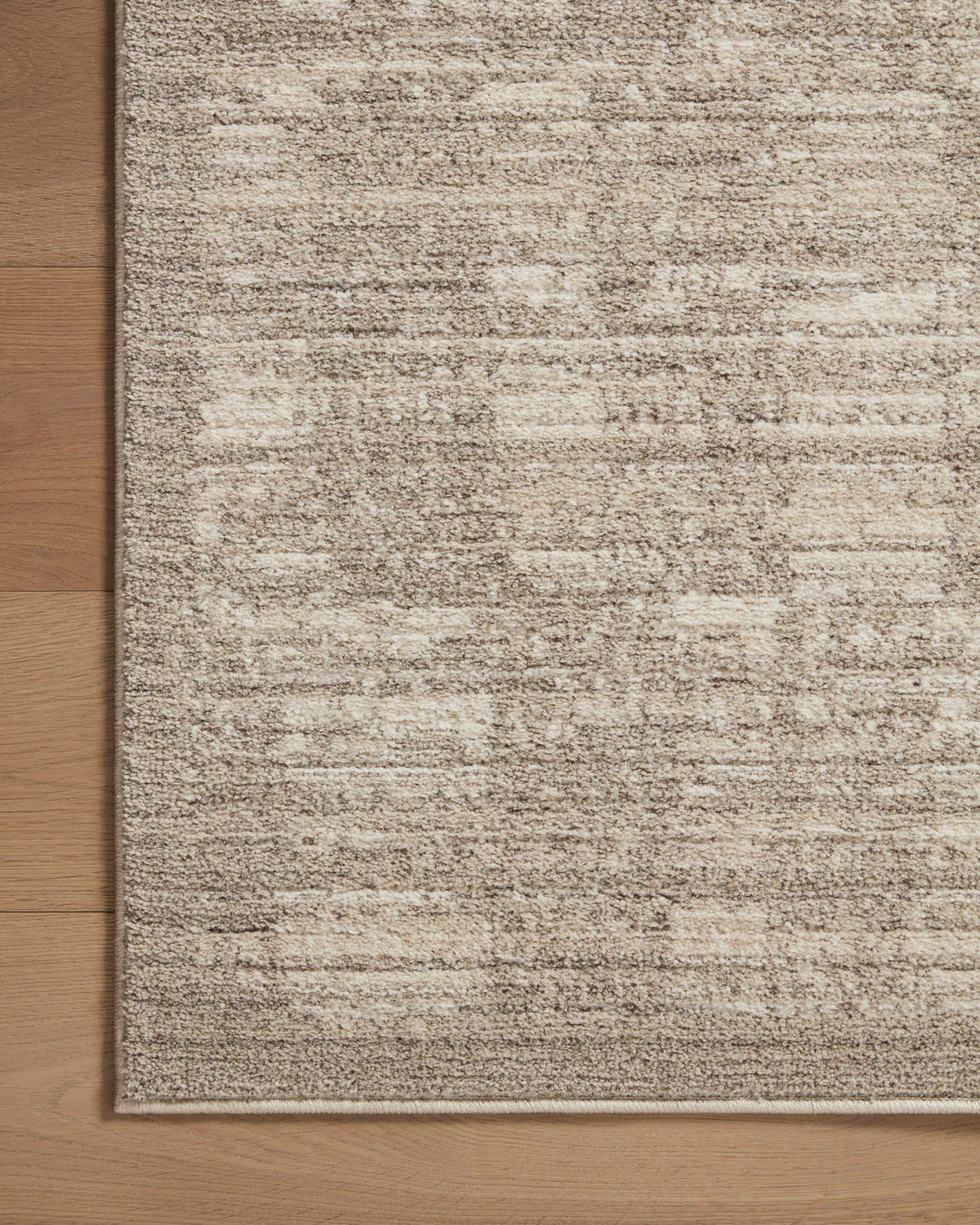 Rectangular sand and pebble textured area rug with muted horizontal stripe lines