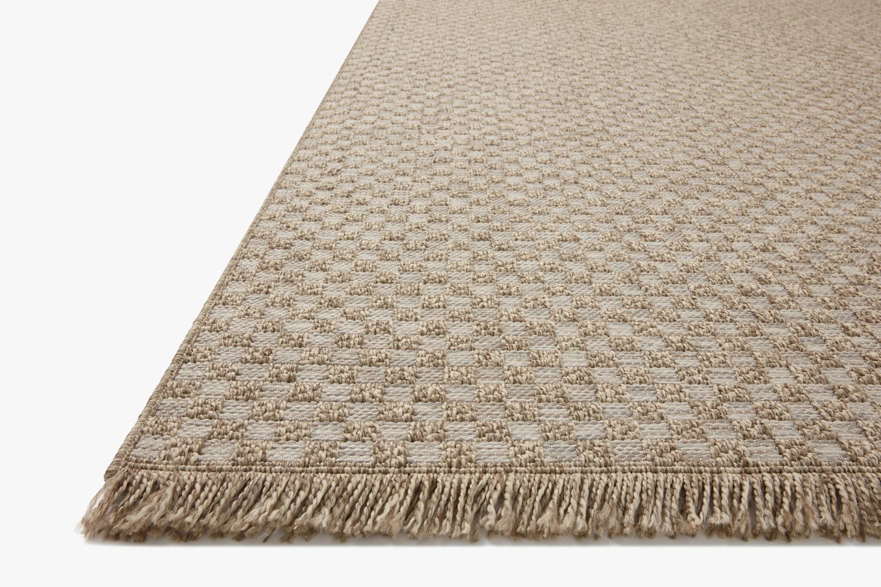 Natural accent rug with small raised check pattern and fringed border