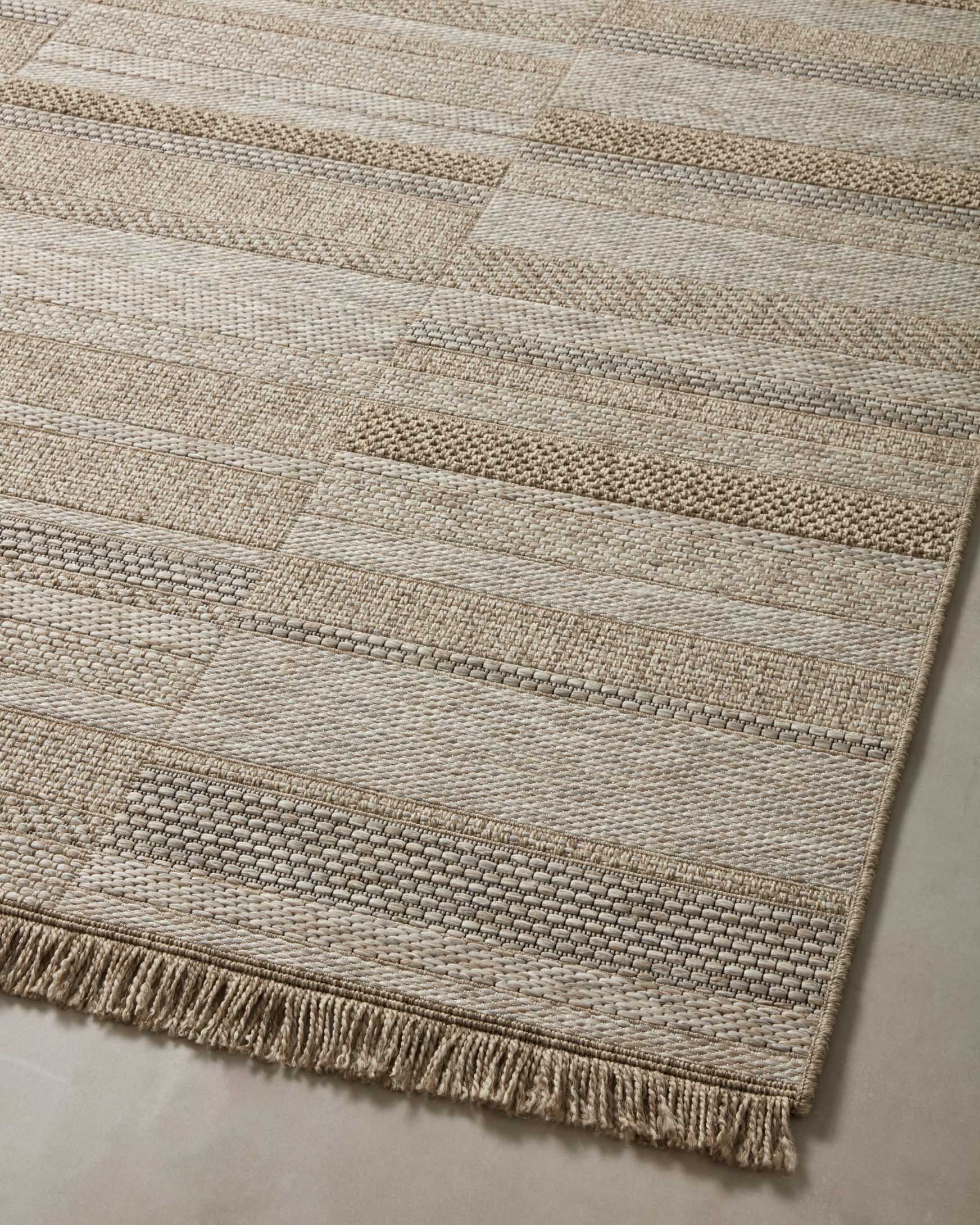 Loloi II natural area rug with patchwork blocks and short fringed border