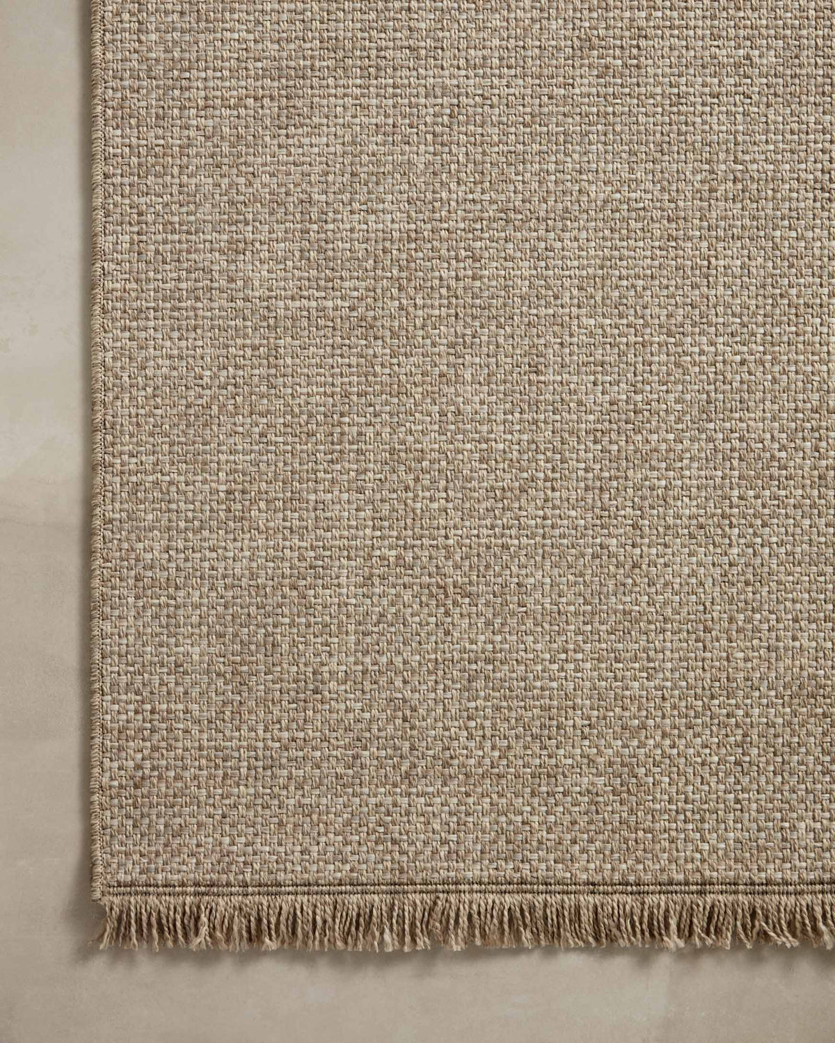 Natural textured runner rug with fringe along the bottom edge