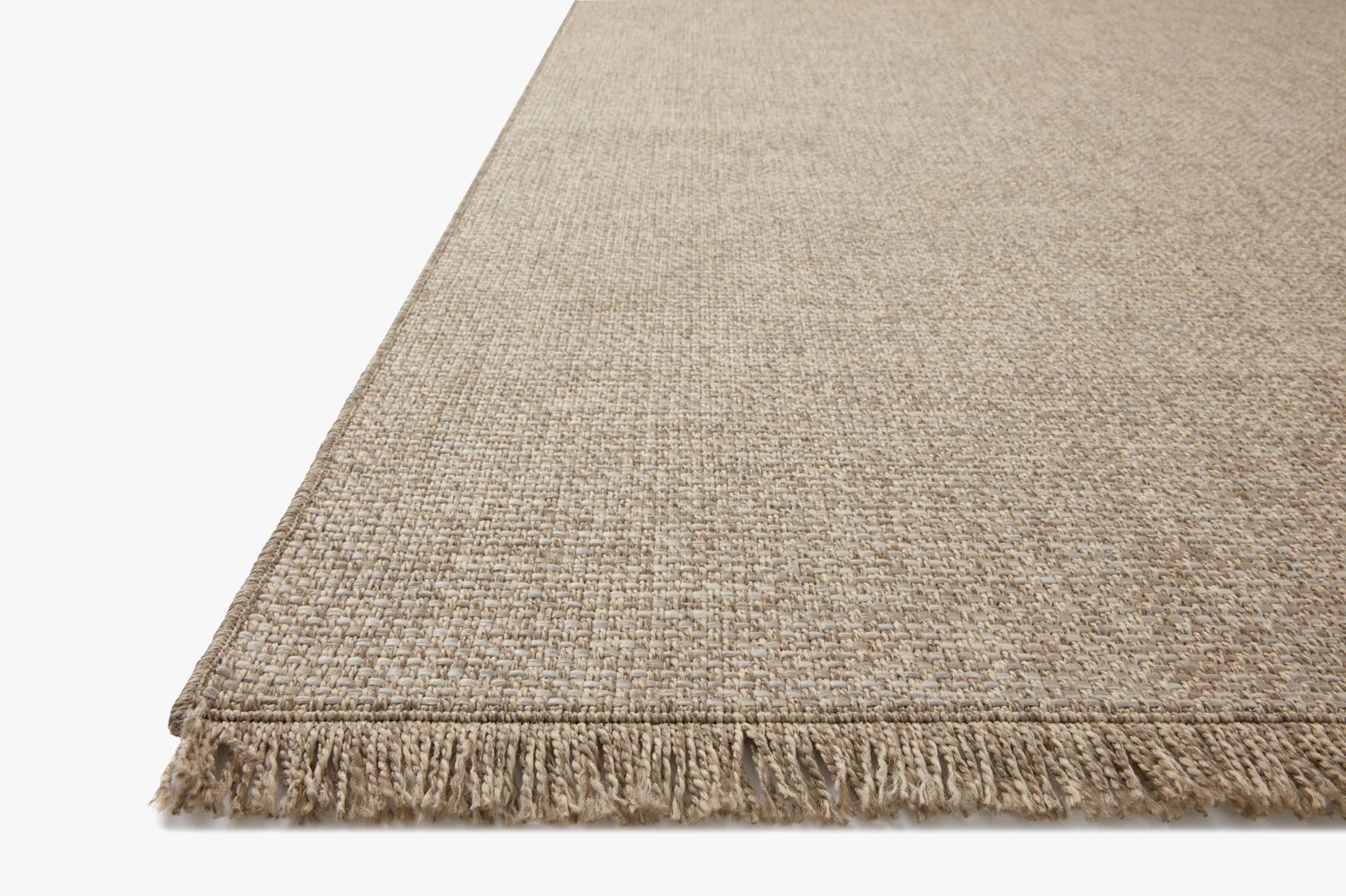 Natural beige textured area rug with short fringed border on the edge