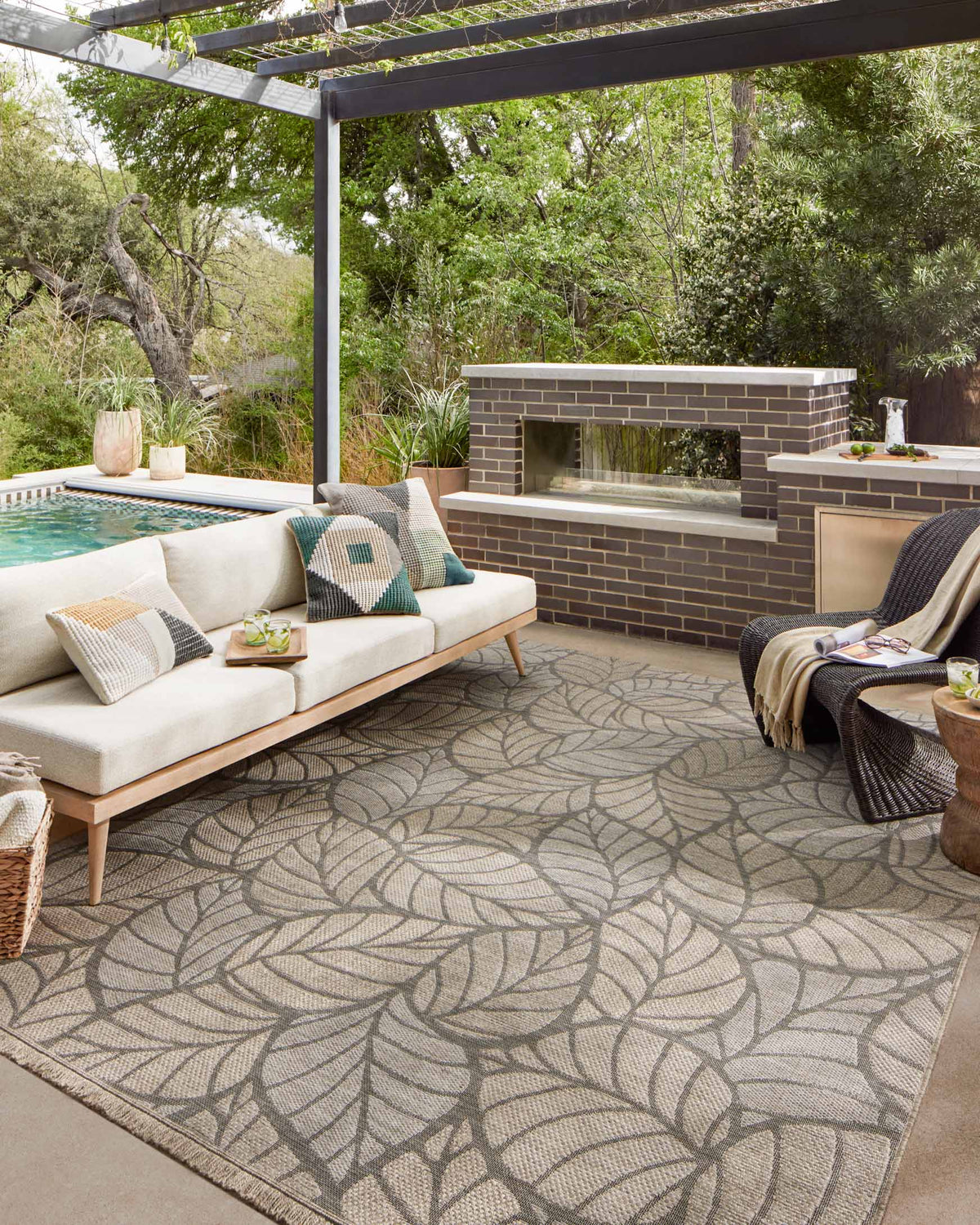 Natural runner rug with gray botanical leaf motif, fringed edges visible