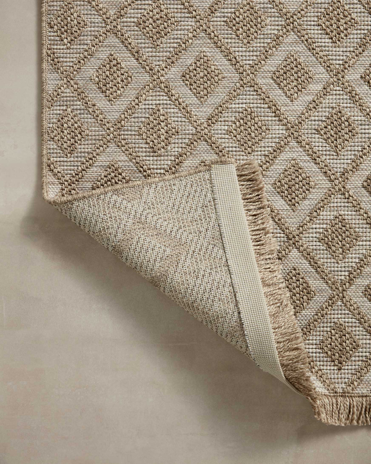 Loloi II natural area rug corner with diamond texture and woven fringe trim