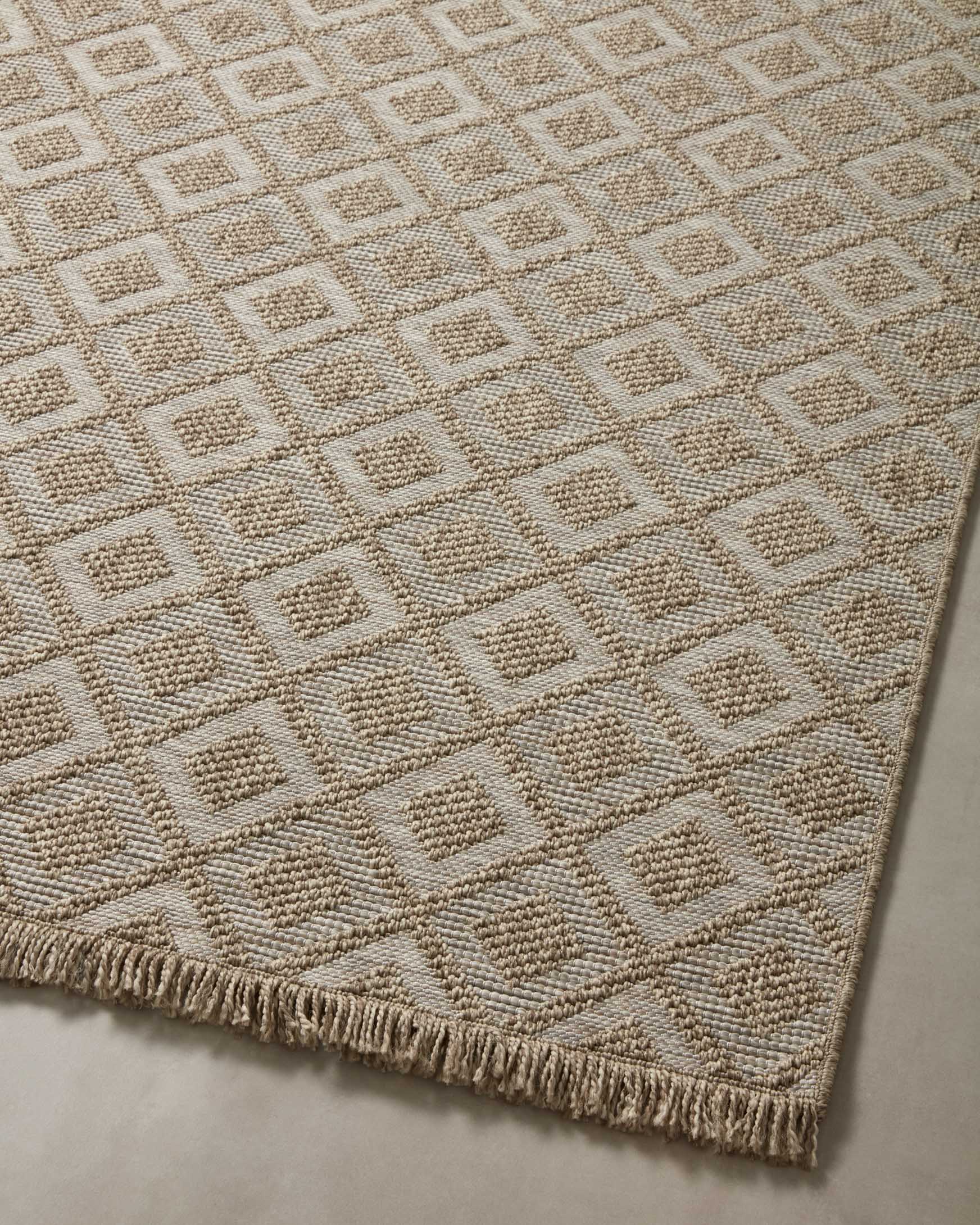 Natural runner rug with repeating square-and-diamond geometric pattern and fringe border