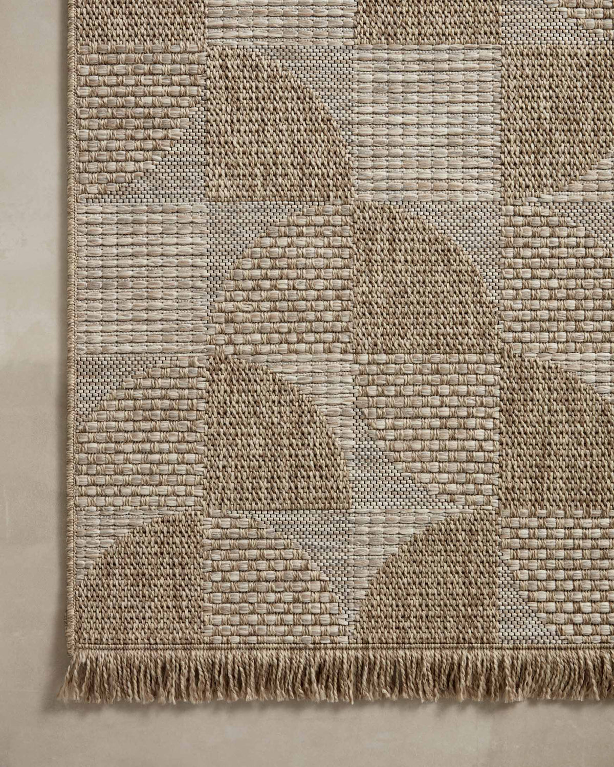 Natural patchwork rug with raised woven blocks and short fringe hem