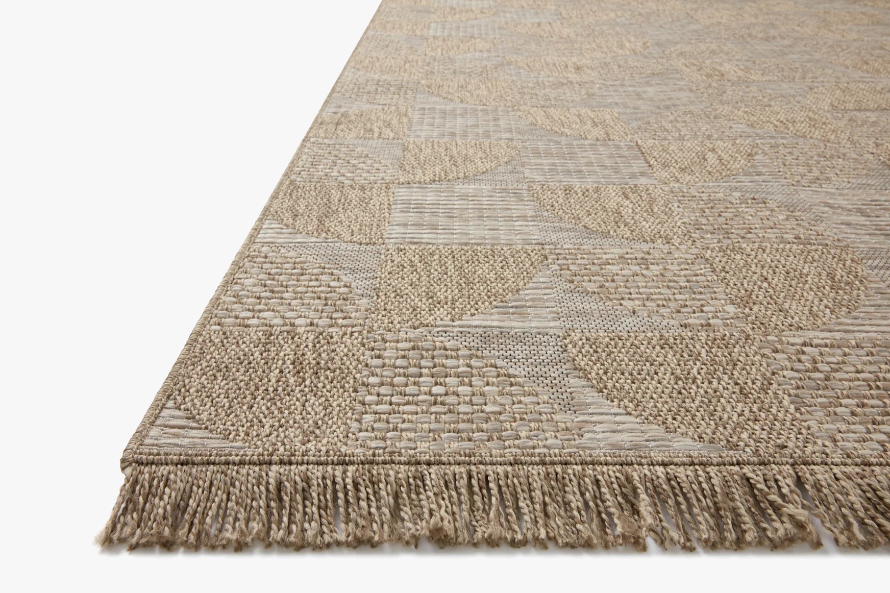 Natural woven area rug with patchwork geometric pattern and short fringed border