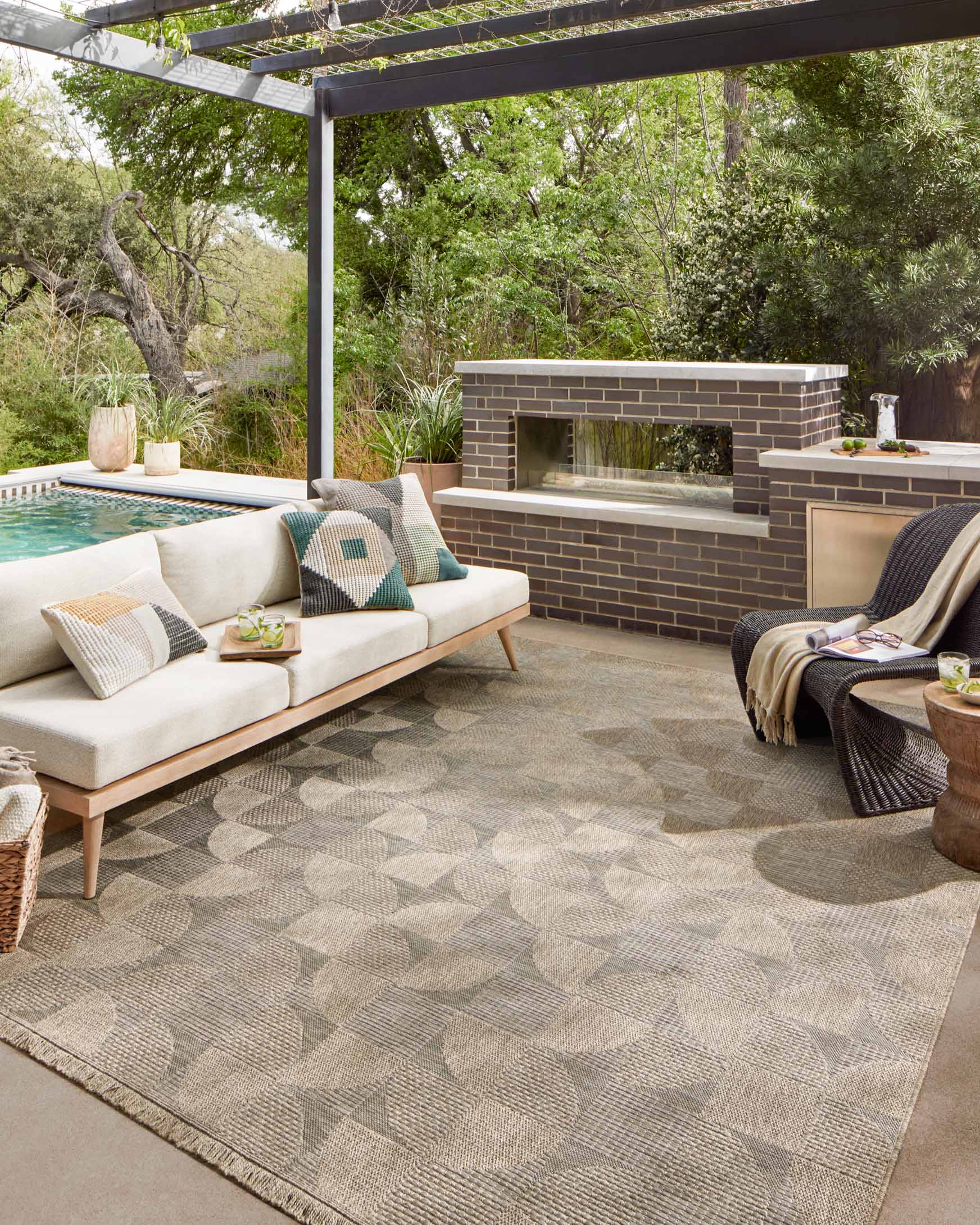 Natural patchwork area rug with geometric pattern, shown on outdoor patio floor
