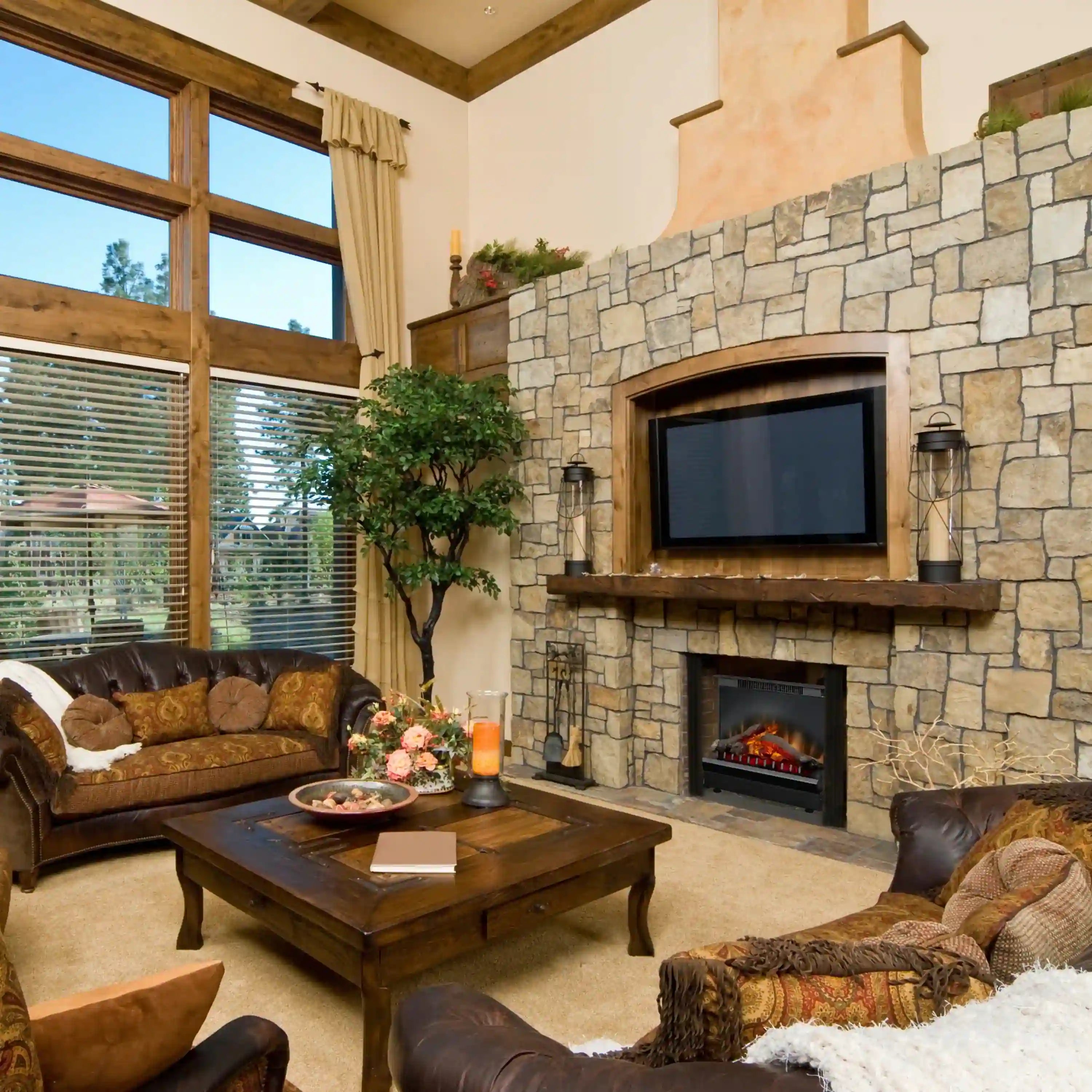 Black electric firebox insert with LED log set in a stone fireplace surround