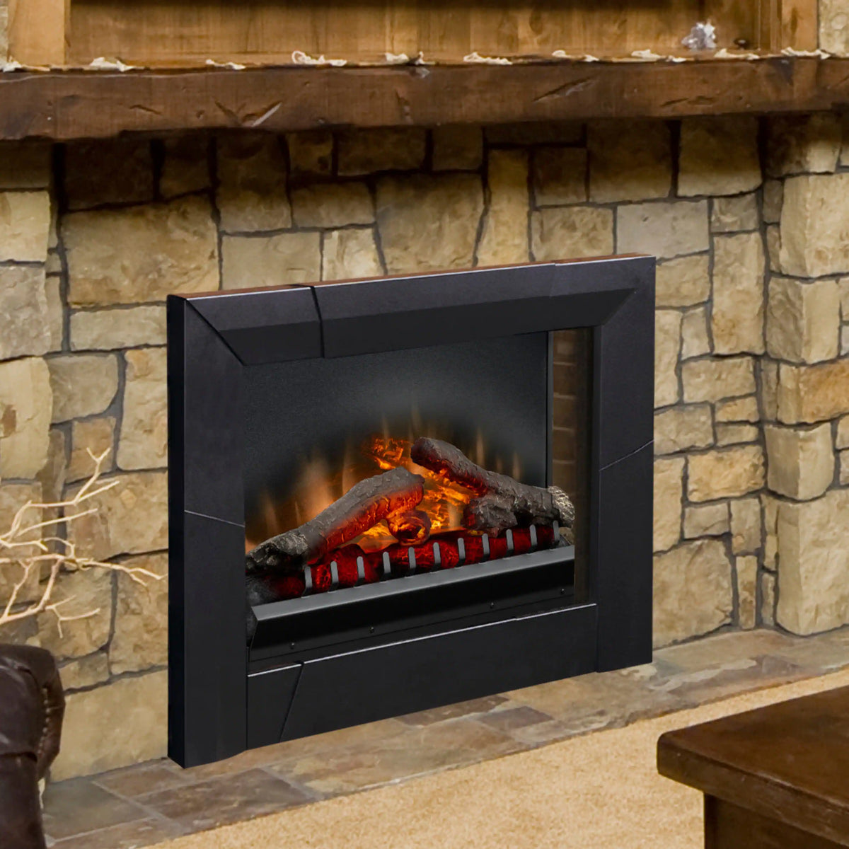 Black electric firebox insert with LED log set installed in a wall fireplace