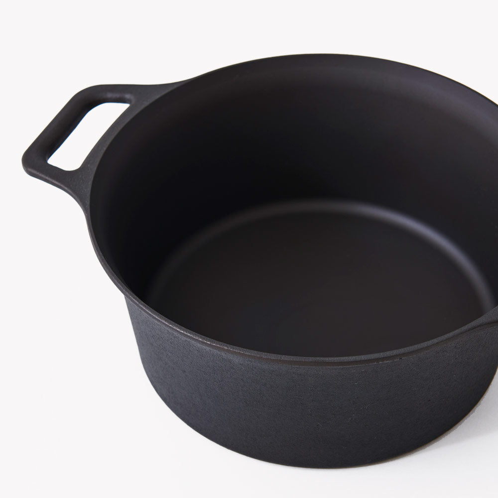 Black cast iron dutch oven pot with side handles, interior view