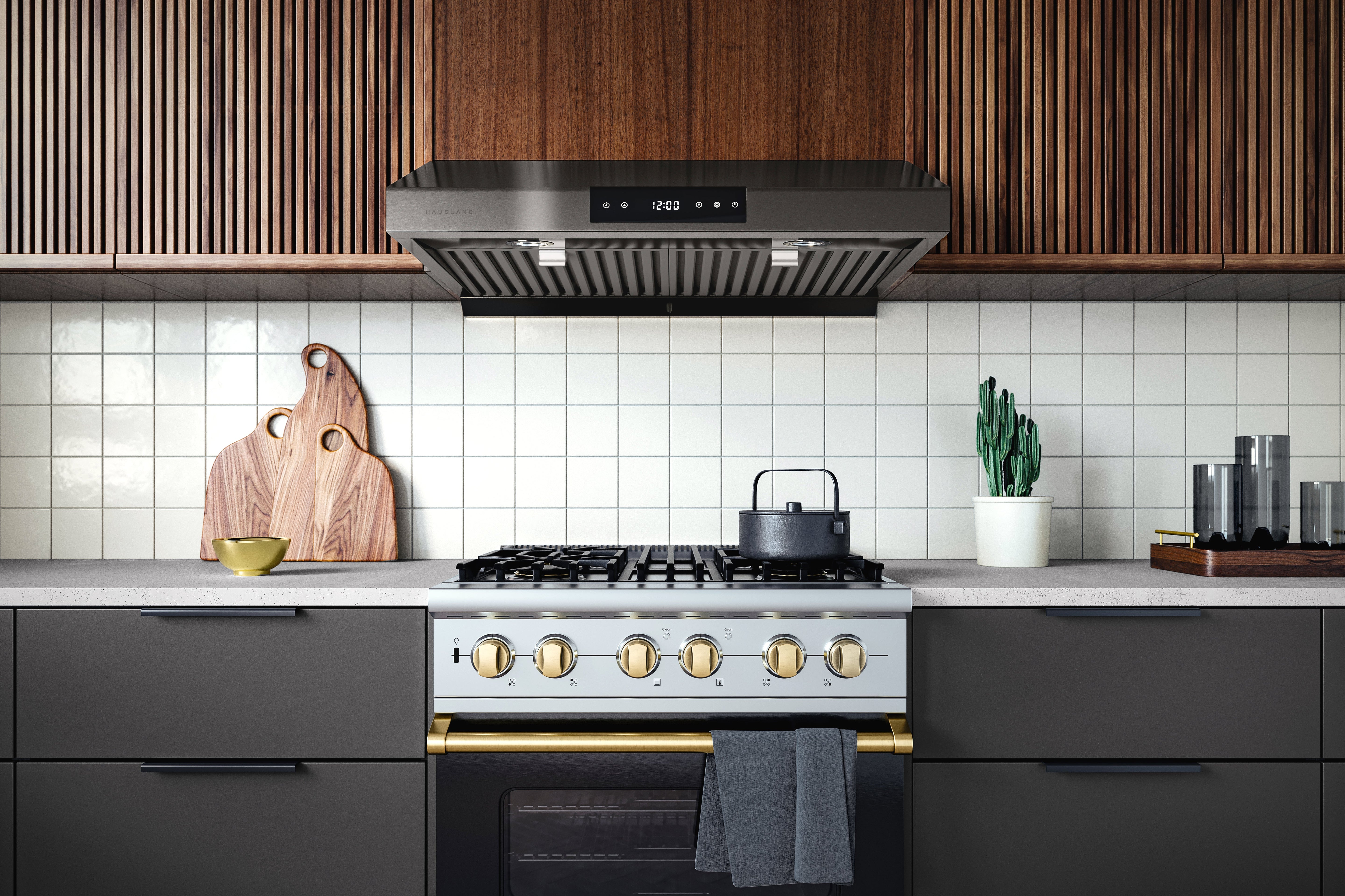 Black stainless under-cabinet range hood centered above the cooktop in a kitchen