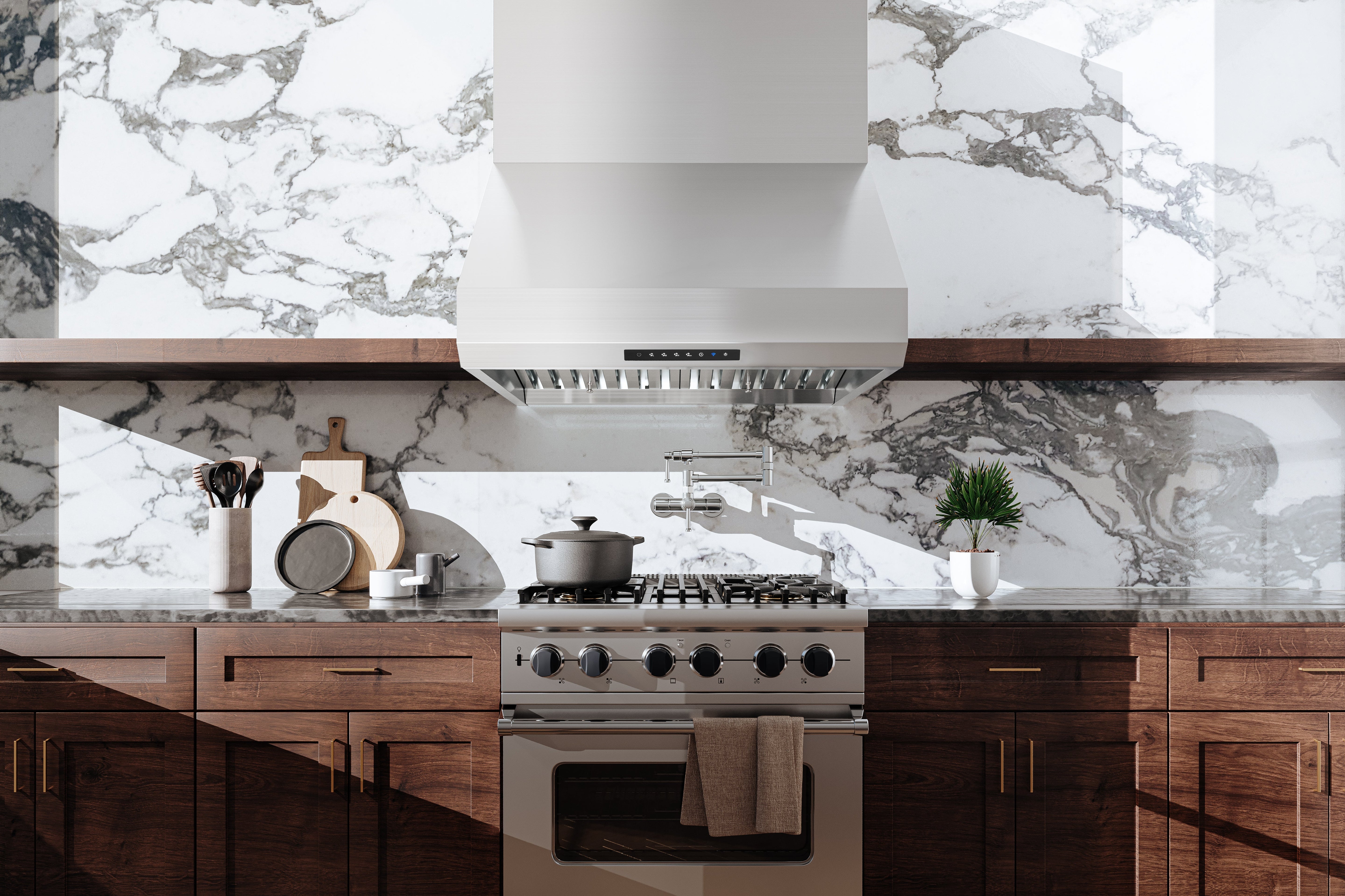 Stainless steel pro-style range hood with control panel above cooktop
