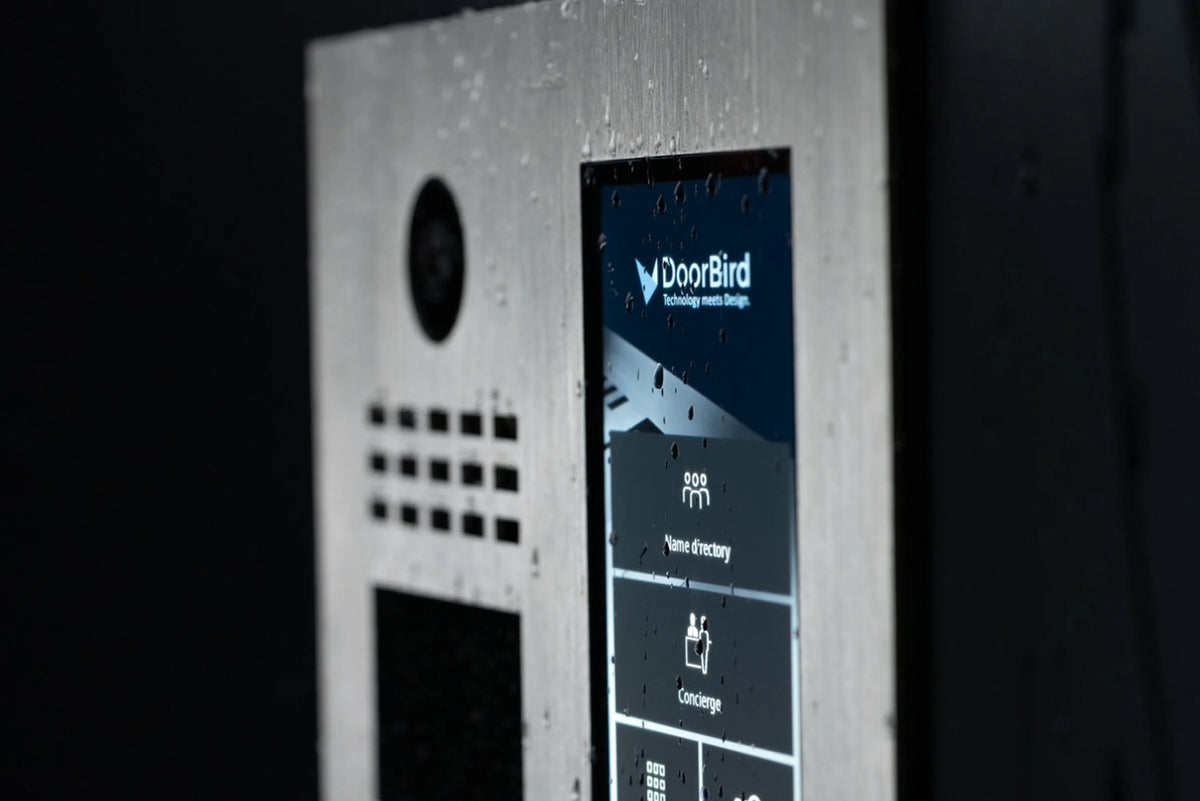 Brushed metal DoorBird video intercom with close-up screen and camera lens