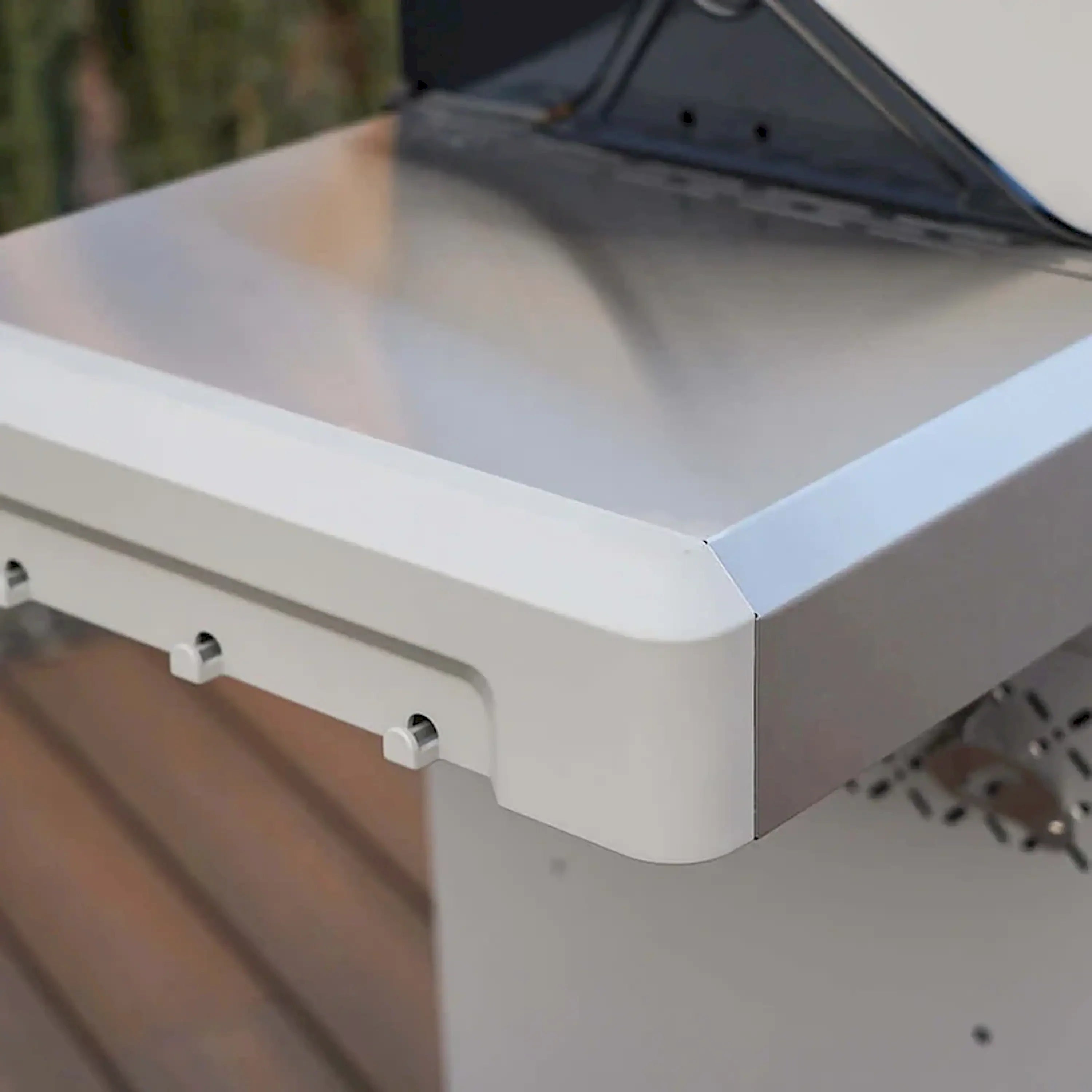 Stainless propane grill side storage area with closed cabinet door