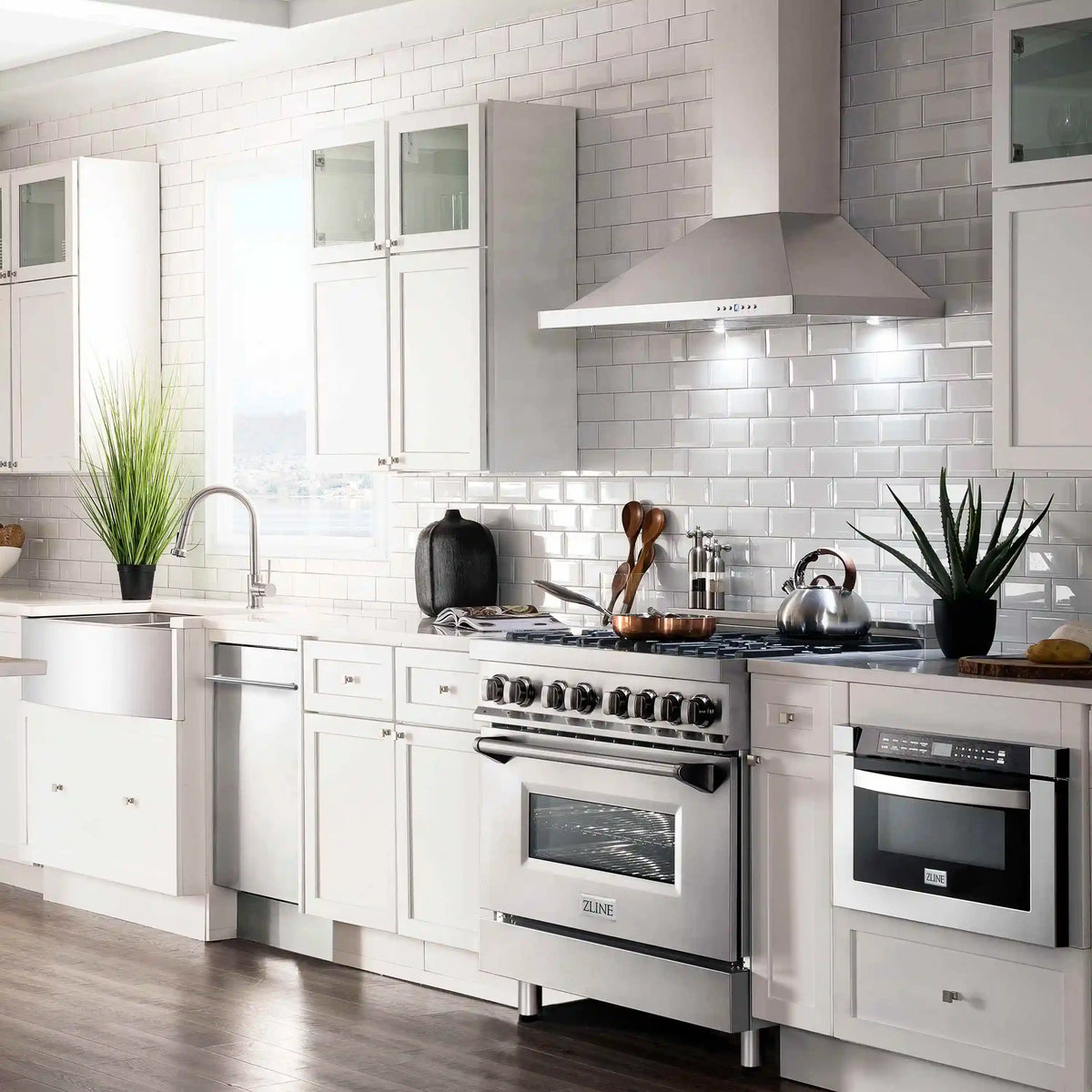 Stainless steel wall mount range hood above a six-burner gas cooktop