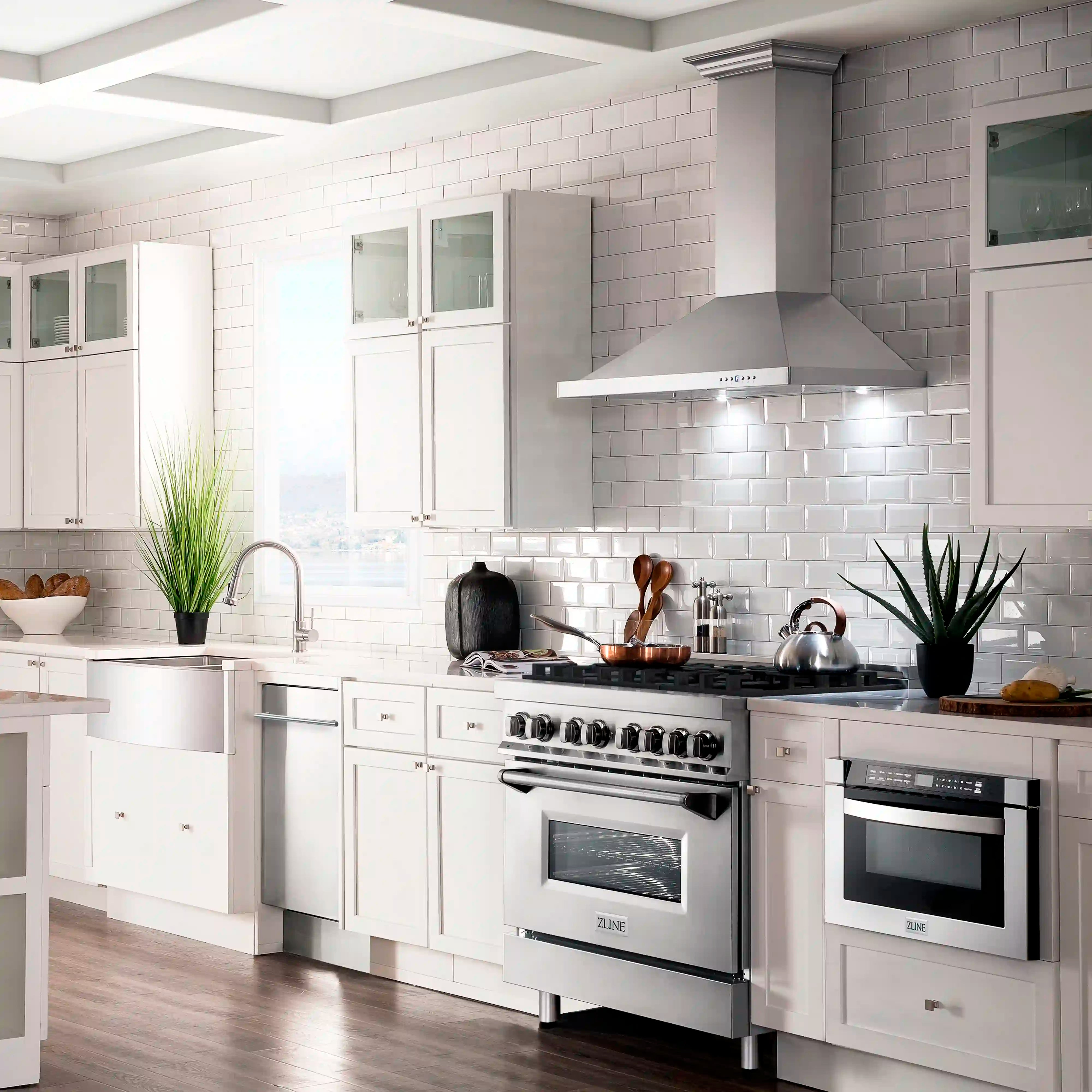 Stainless dual-fuel range with oven door and gas cooktop in a white kitchen