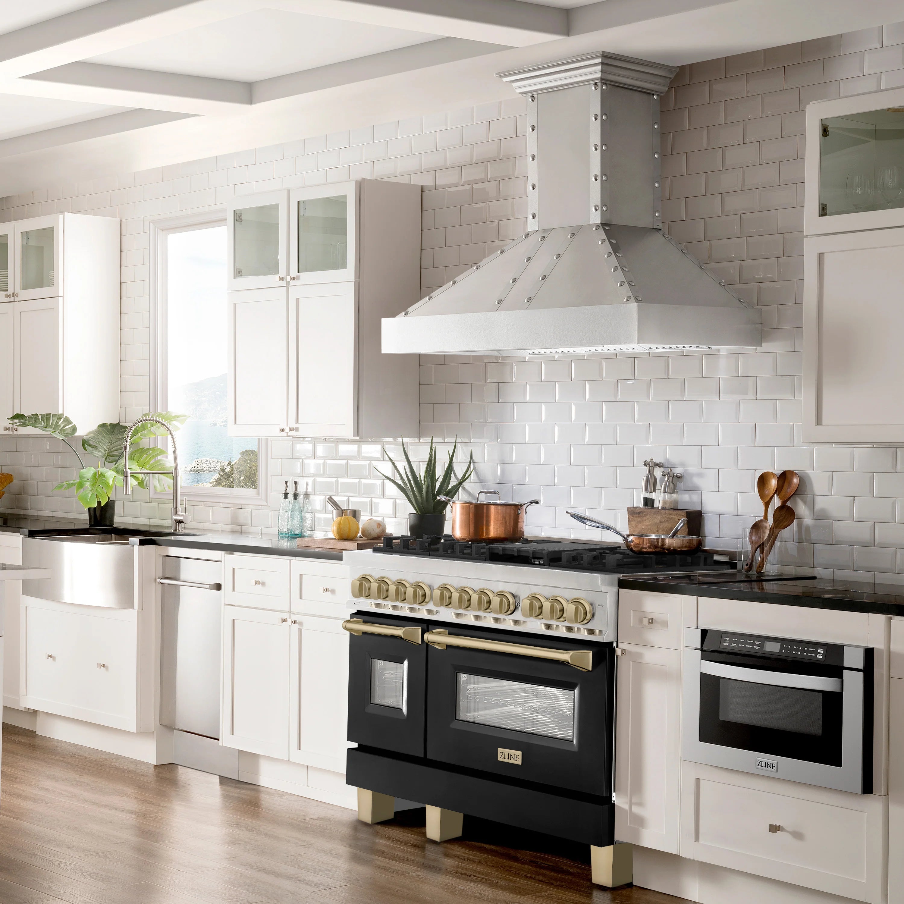 Stainless steel dual fuel range with black matte oven doors and champagne bronze accents