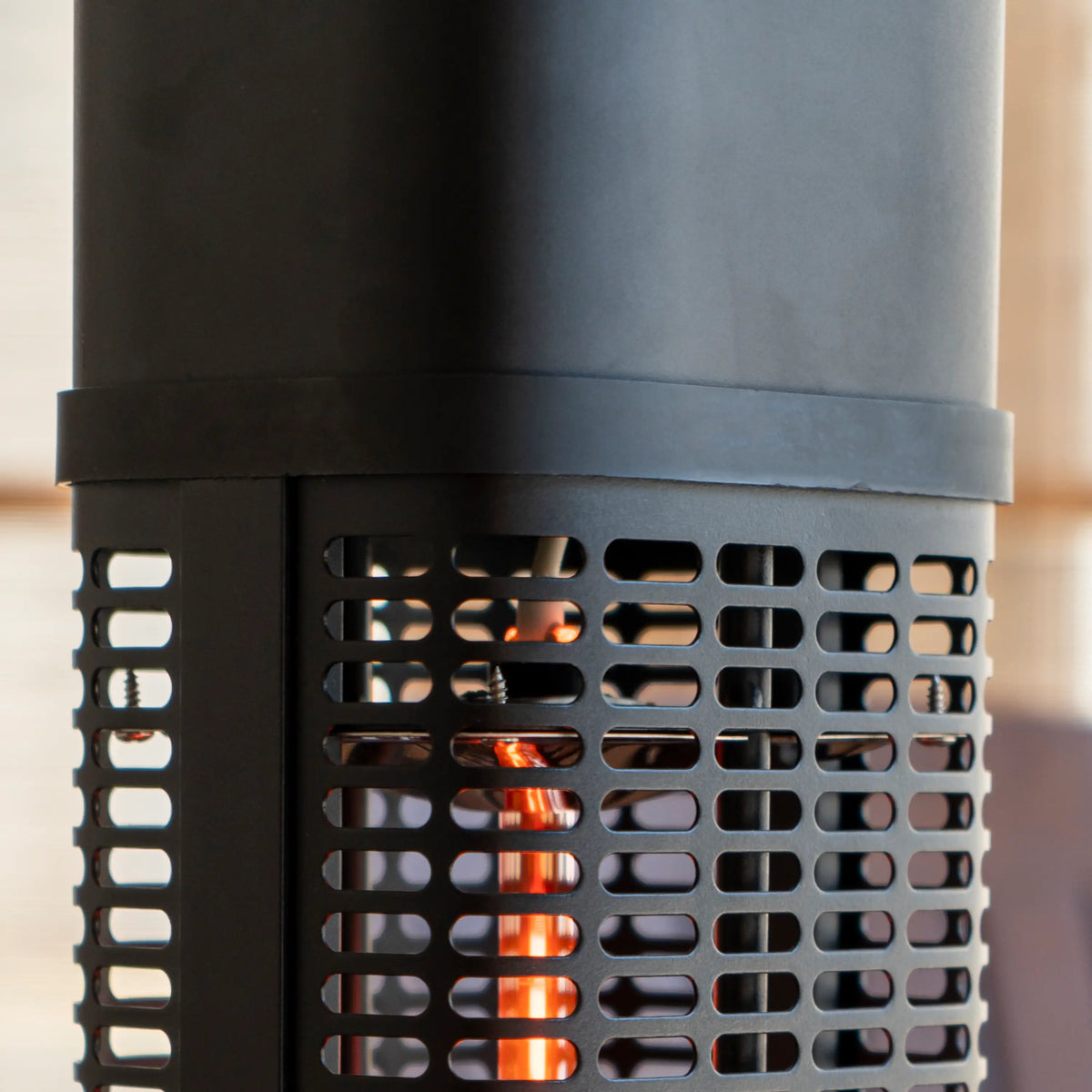 Close-up of black heater grille showing glowing halogen heating elements