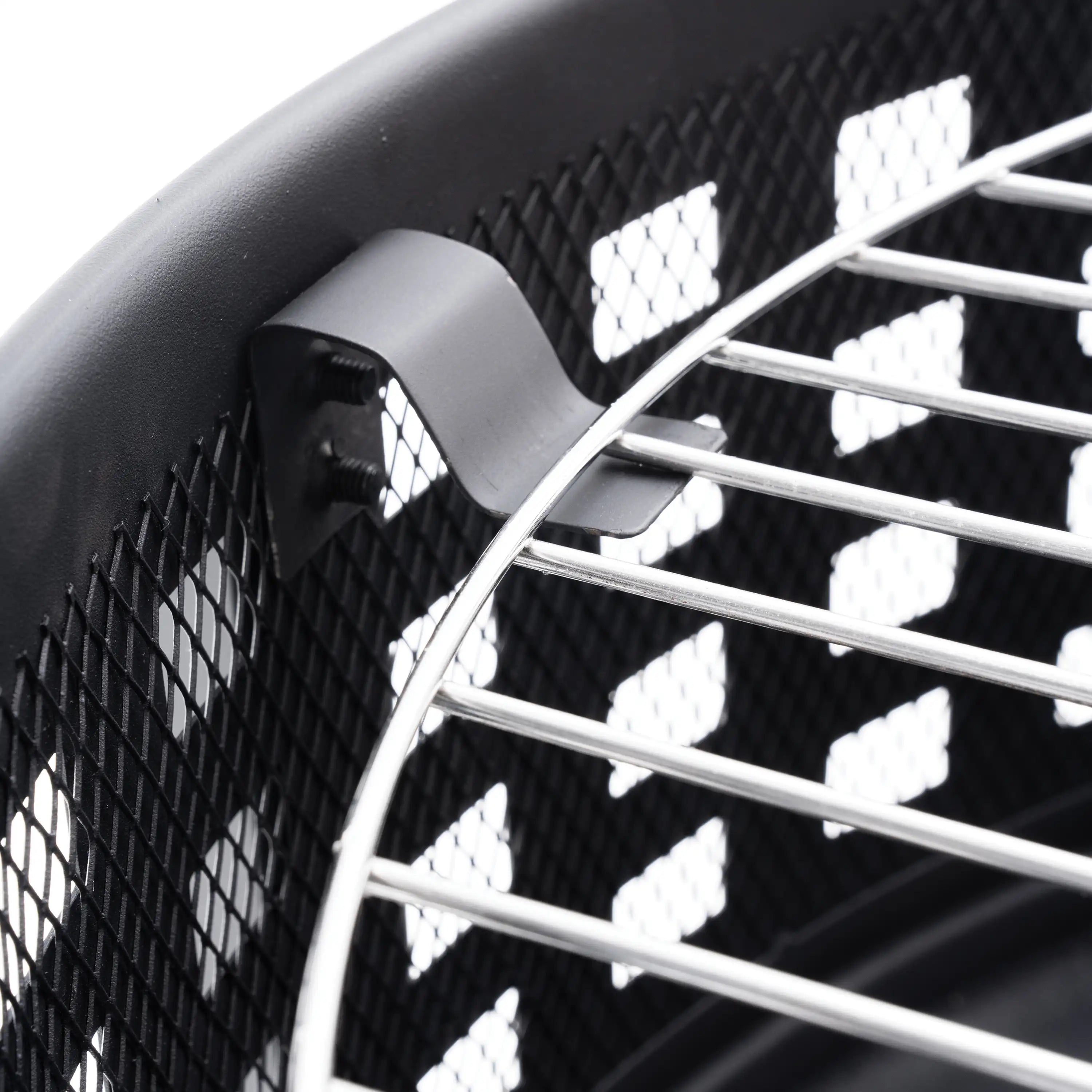 Close-up of curved metal grilling grate and mesh spark screen on the fire pit