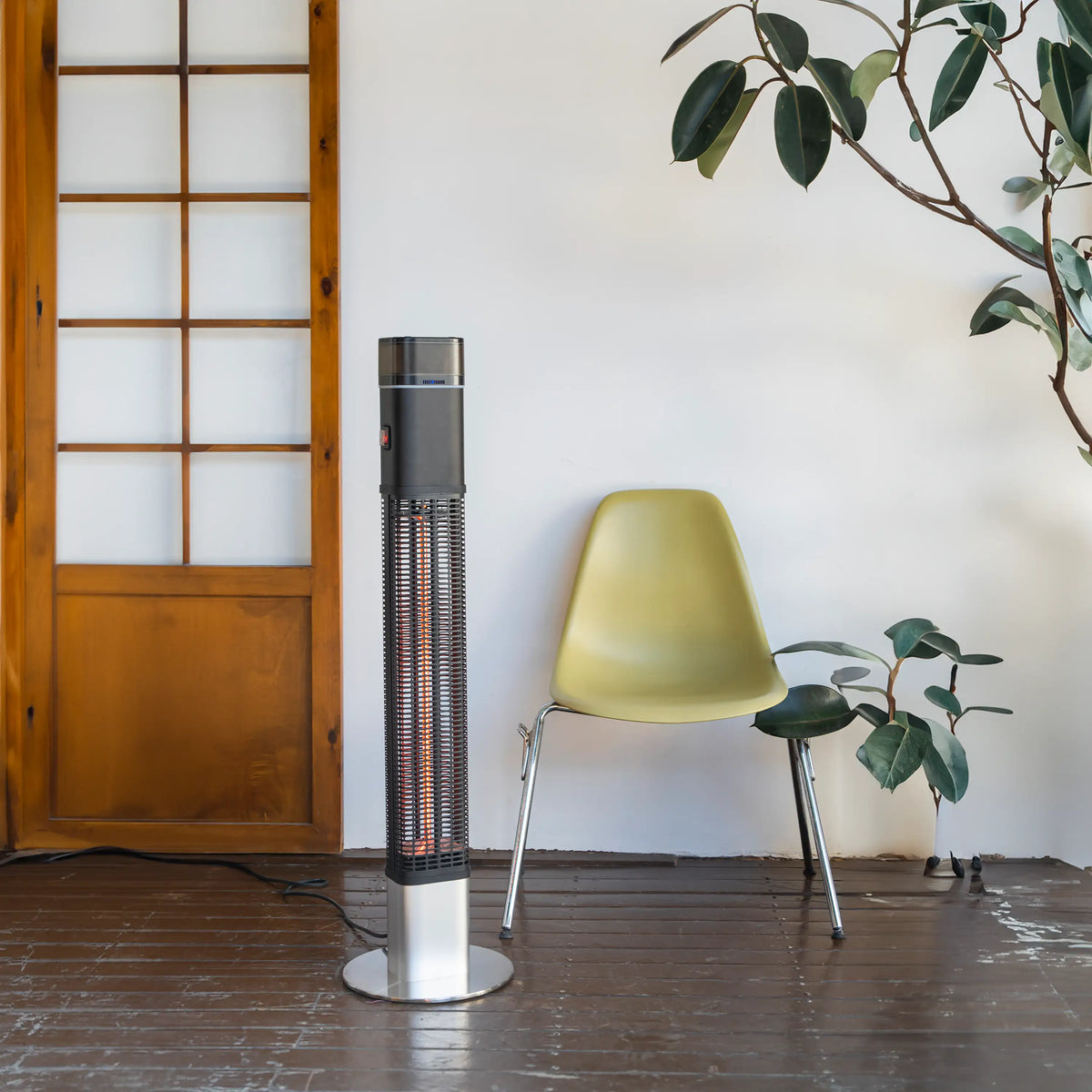 Freestanding black halogen column heater with glowing heating tube and round base