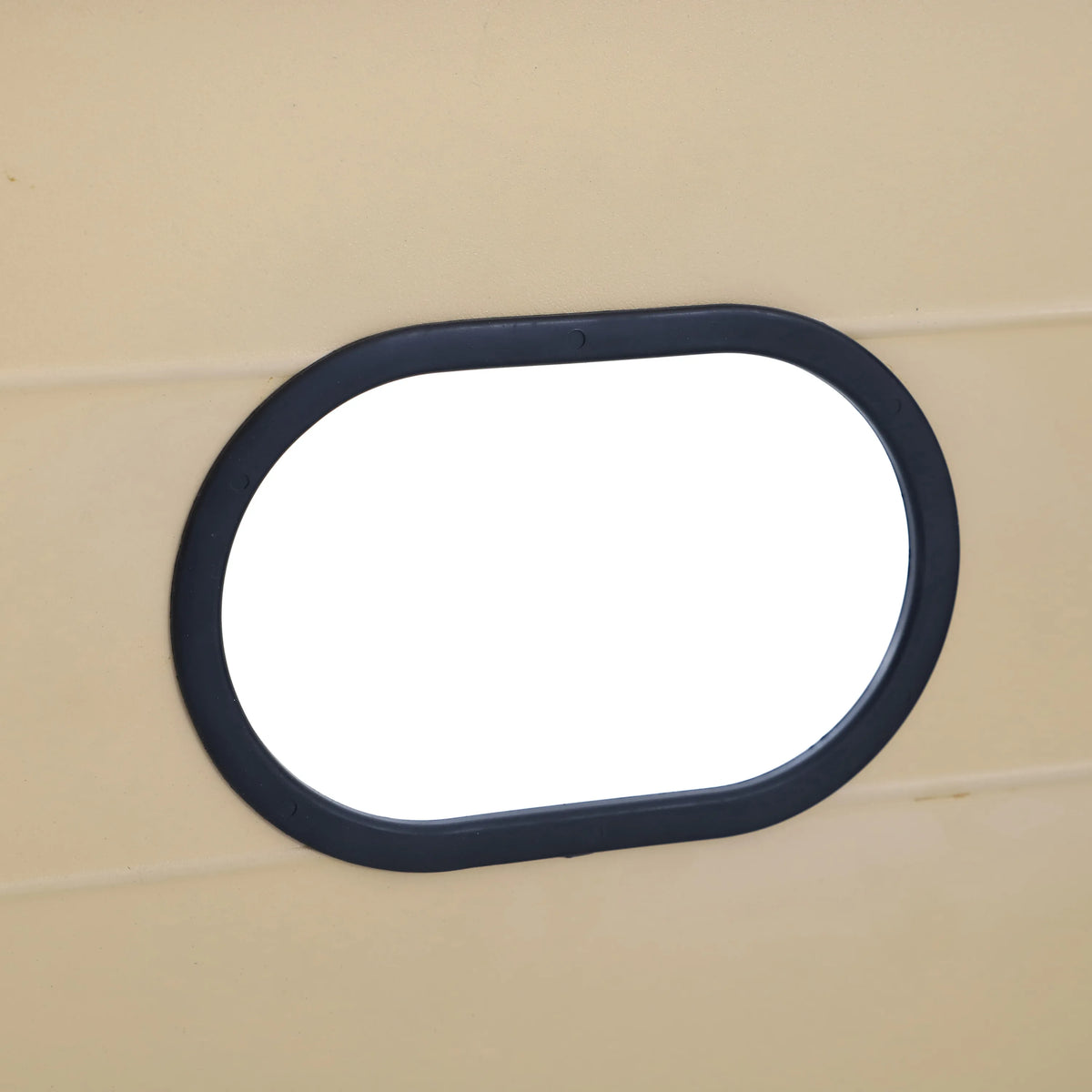 Black oval trim on tan wood panel for propane fire pit table access