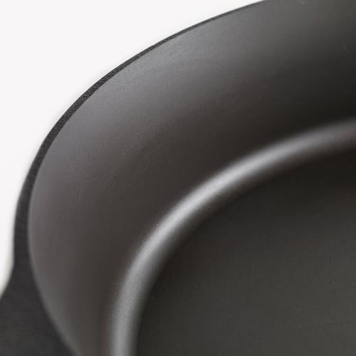 Close-up of dark skillet interior with smooth nonstick surface