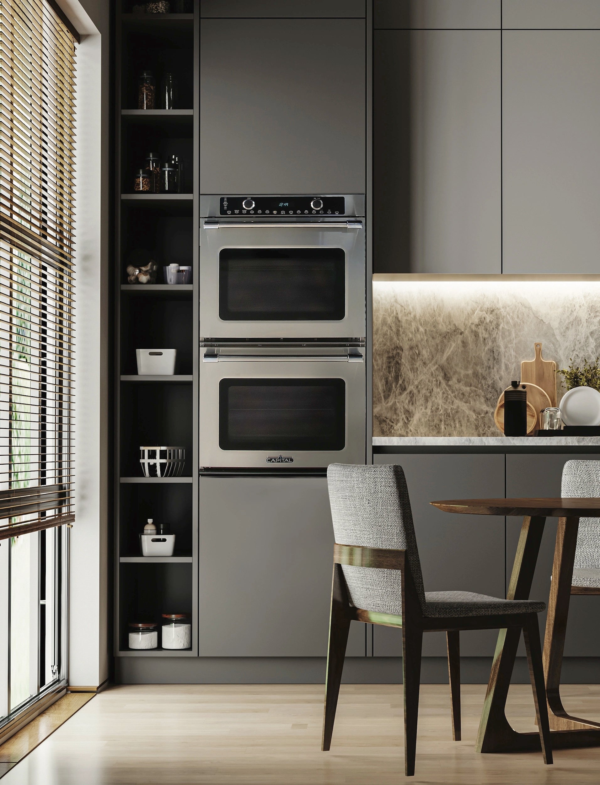 Stainless steel double wall oven installed in a kitchen cabinet with stacked doors