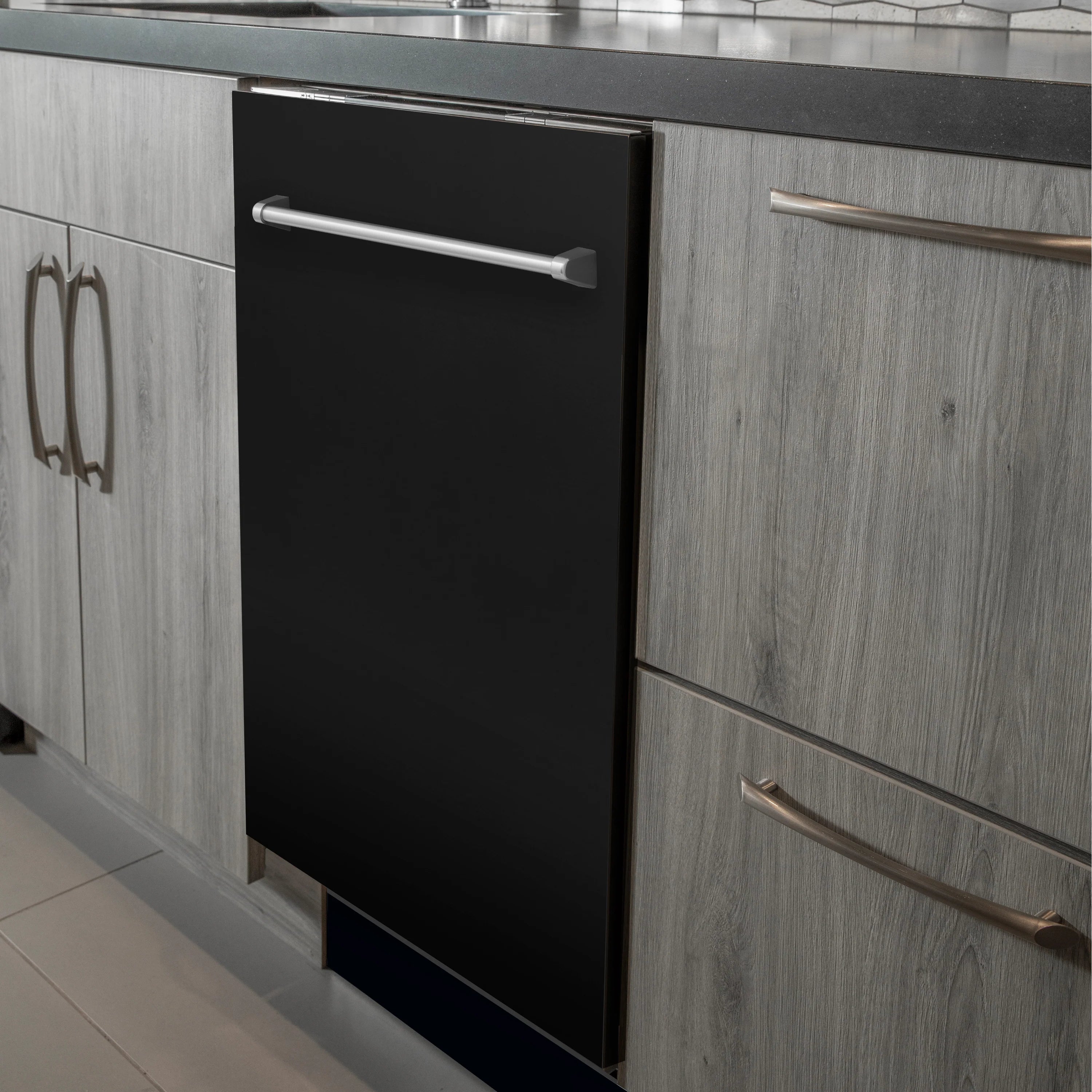Black matte built-in dishwasher door with stainless handle, installed in kitchen