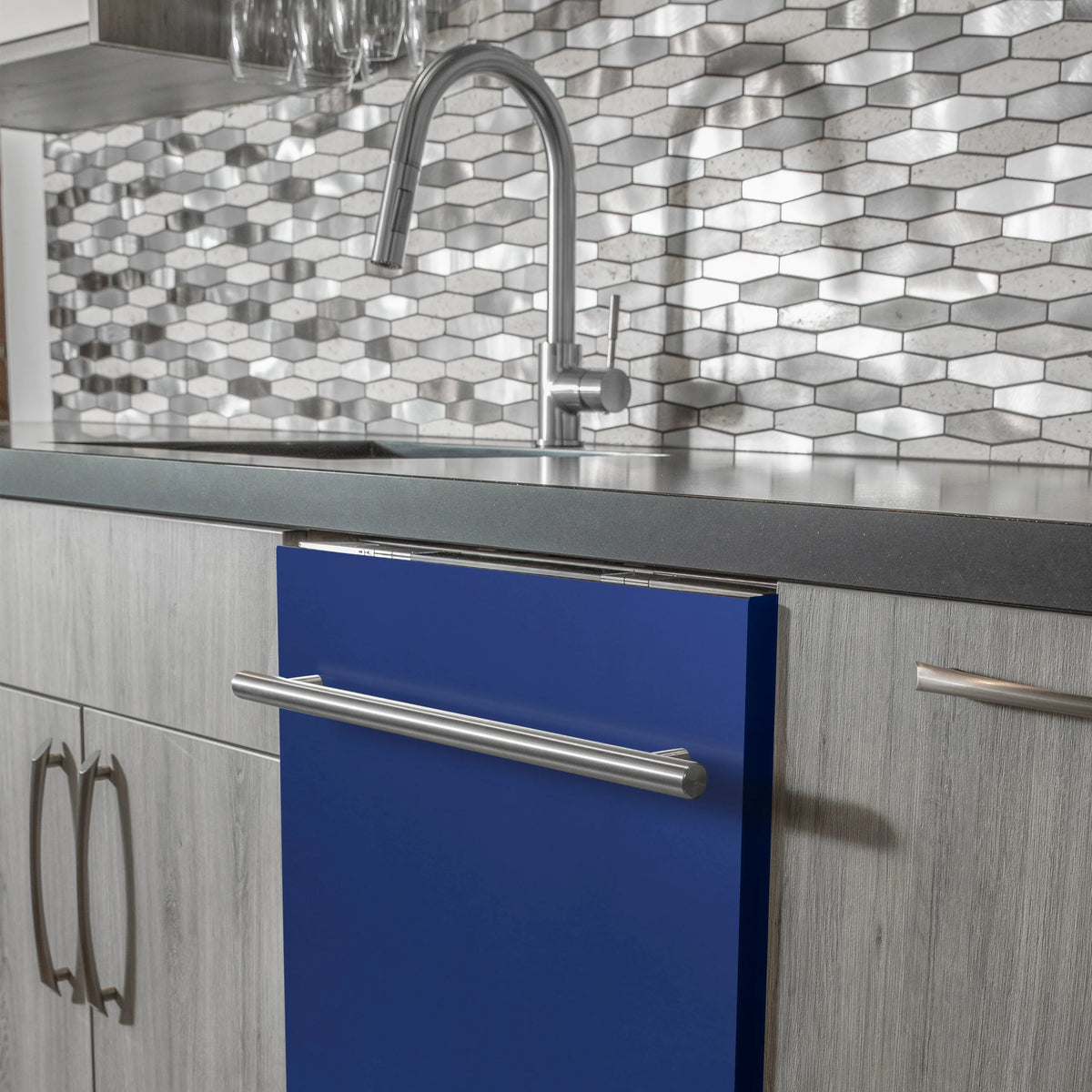Blue matte dishwasher door with stainless steel handle bar installed in cabinetry
