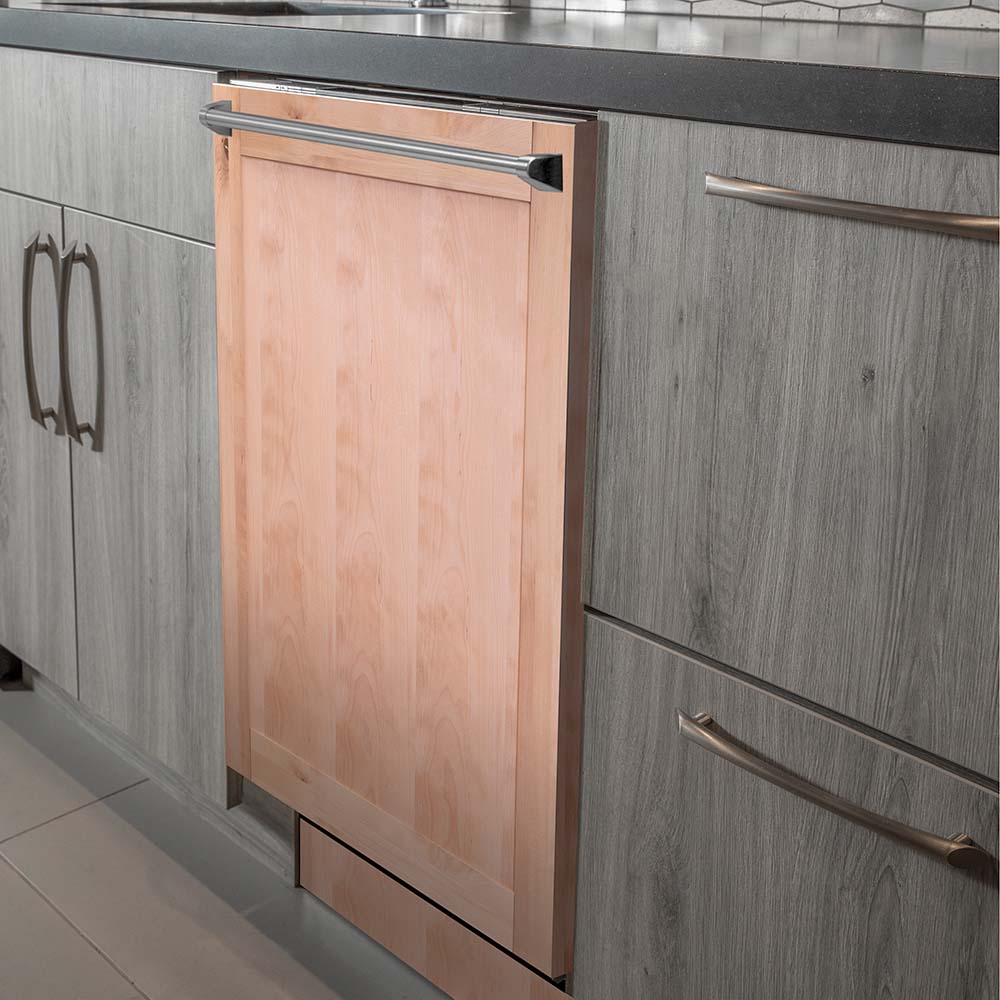 Built-in dishwasher with unfinished wood door panel and long metal traditional handle