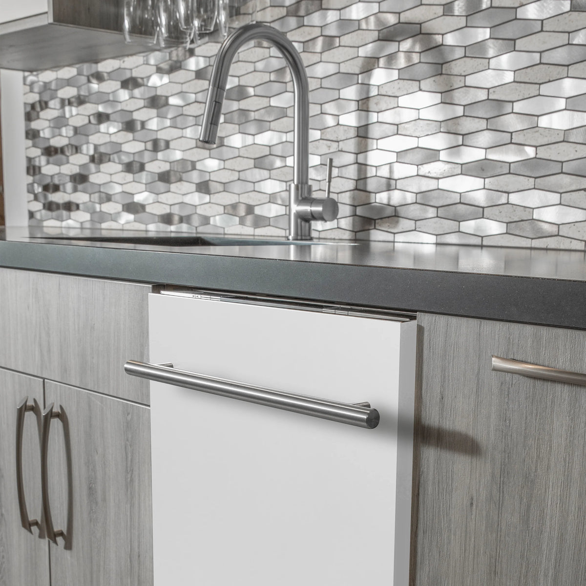 Built-in dishwasher door with stainless handle above dish rack area