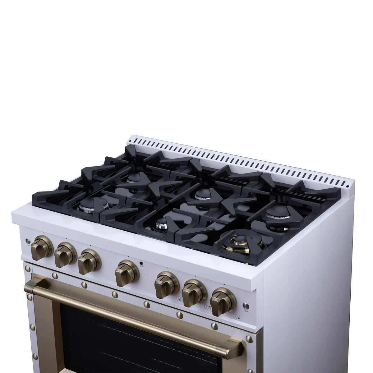 White dual fuel range with black gas burners and brass knobs on the cooktop