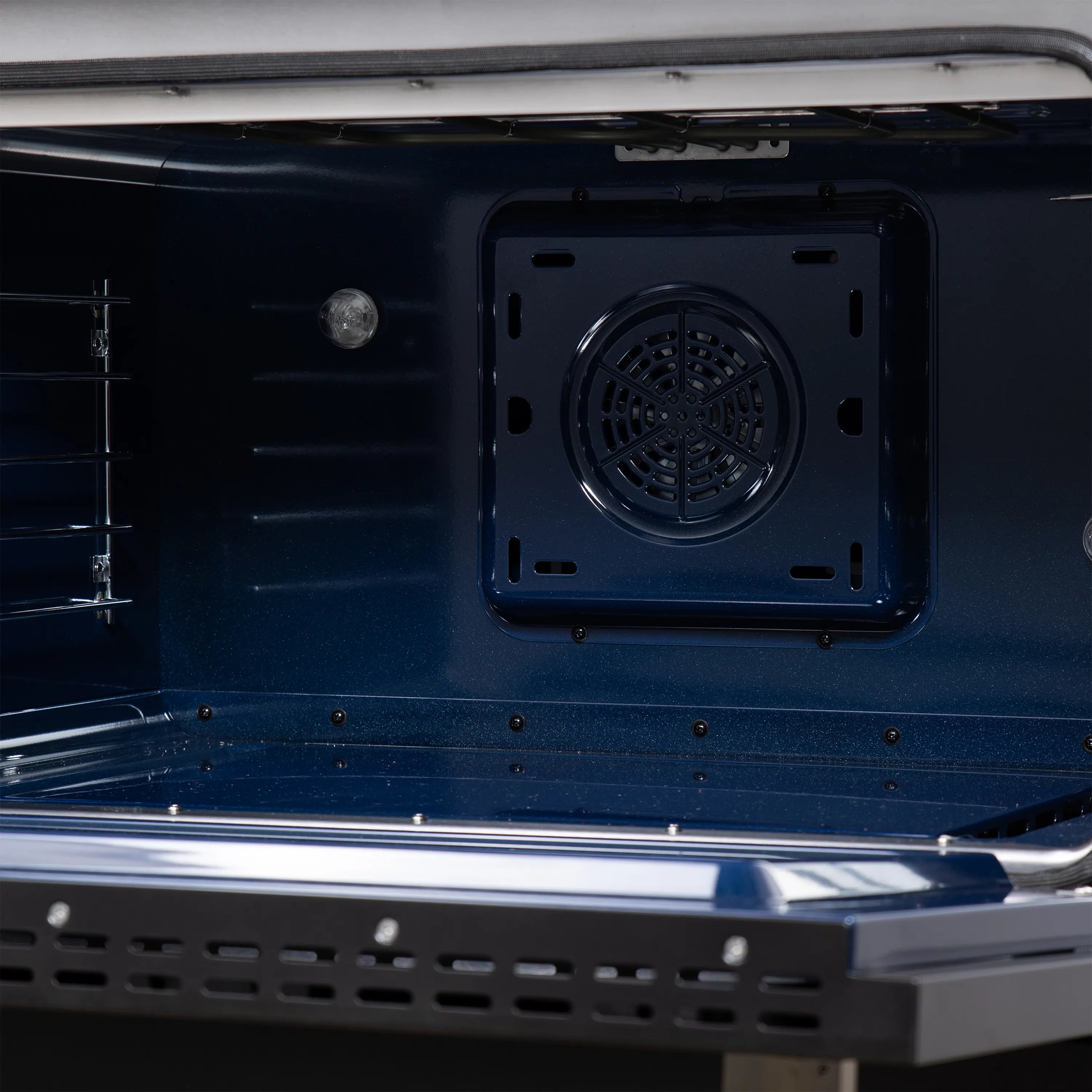 Freestanding range oven cavity with fan vent panel and rack rails