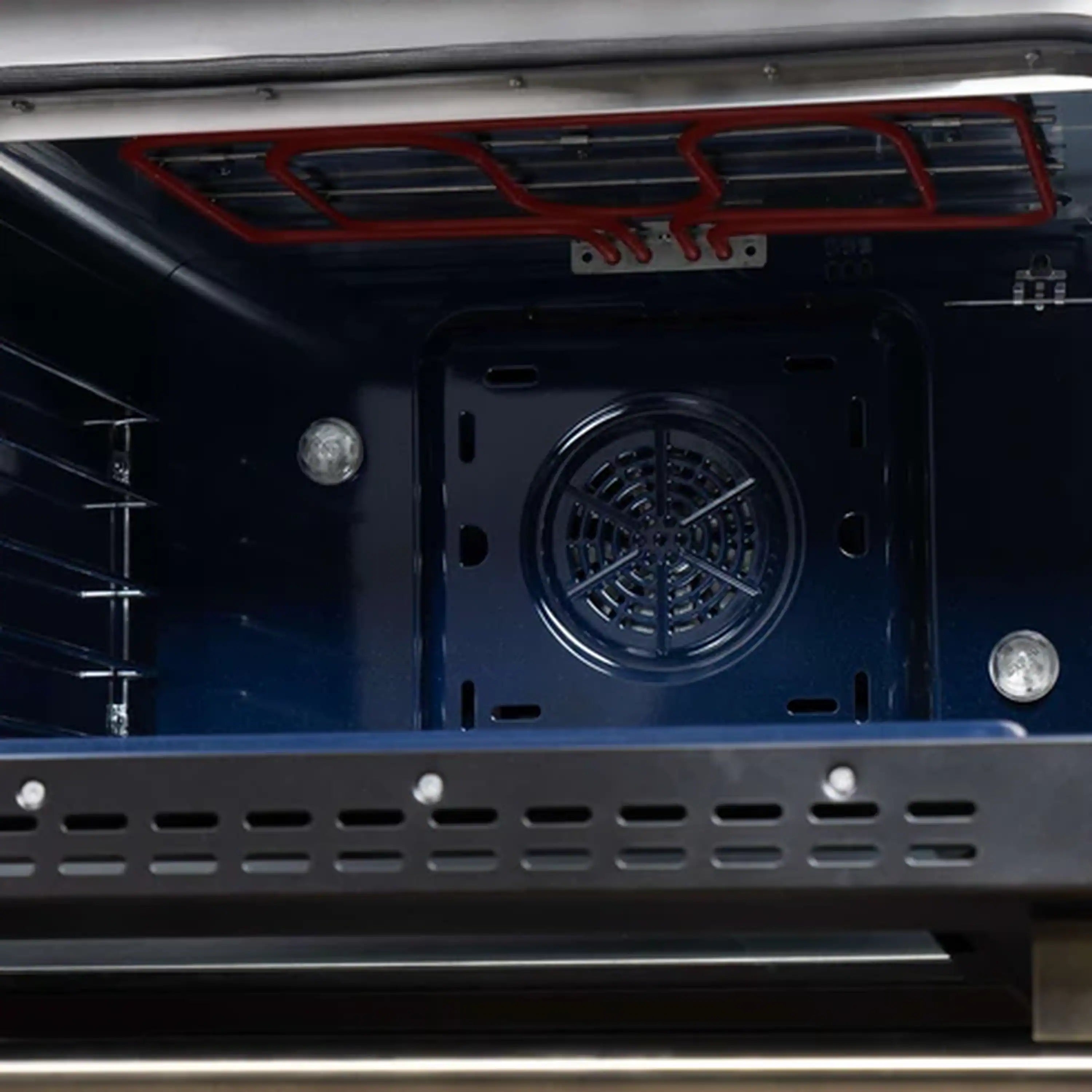 Convection oven door interior with circular fan vent and metal heating cavity