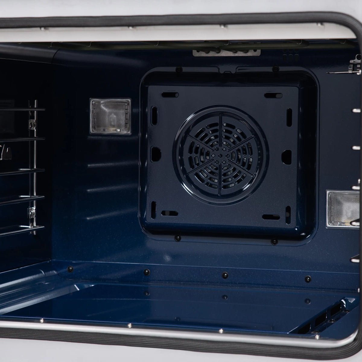 Dual fuel oven with interior view, circular fan vent and side rack supports.