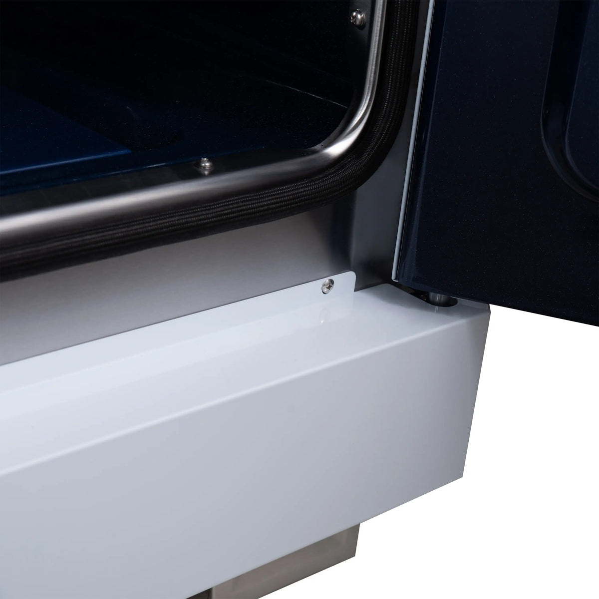 White range side panel with curved stainless trim near the open oven door