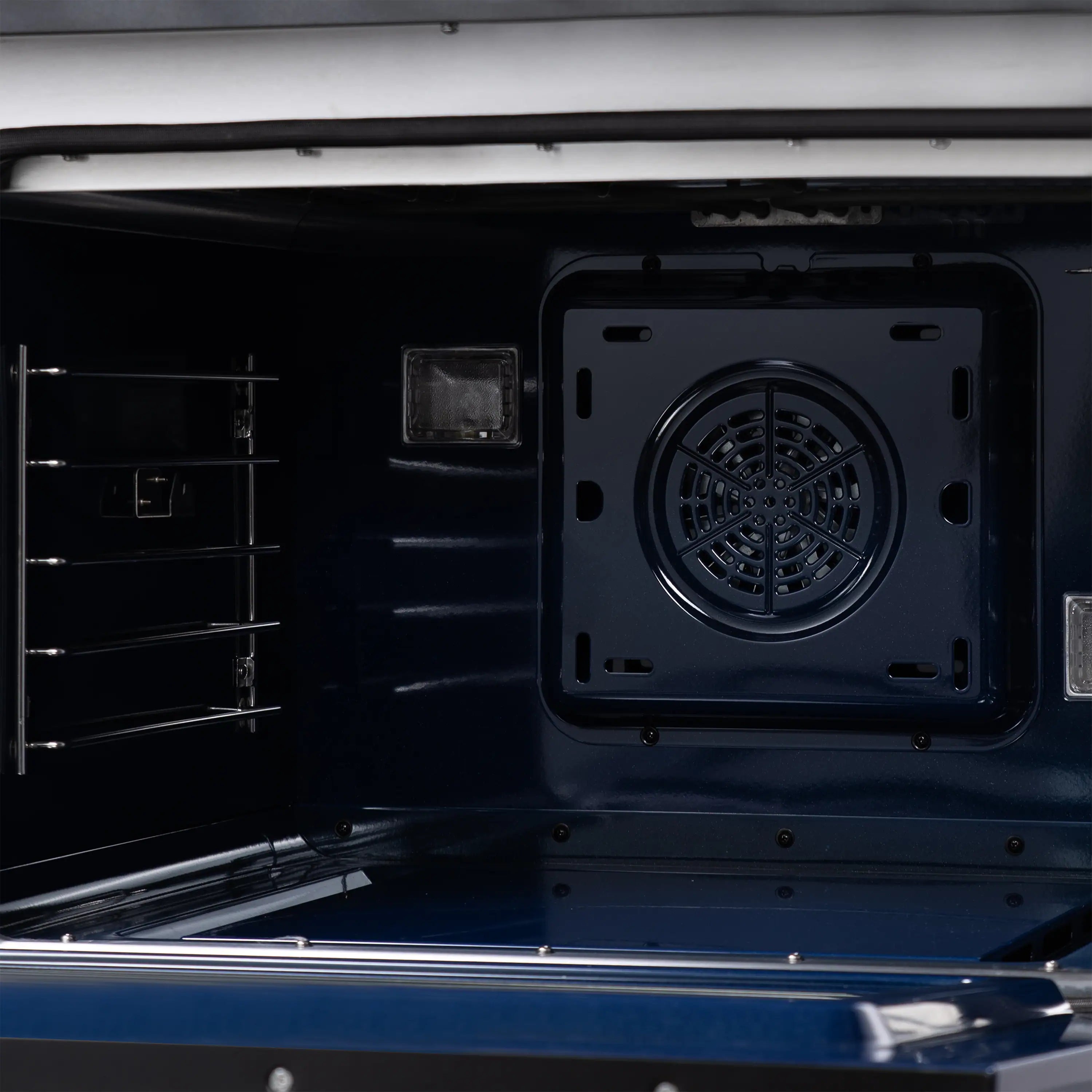 Oven interior fan and vent opening on a black freestanding dual fuel range