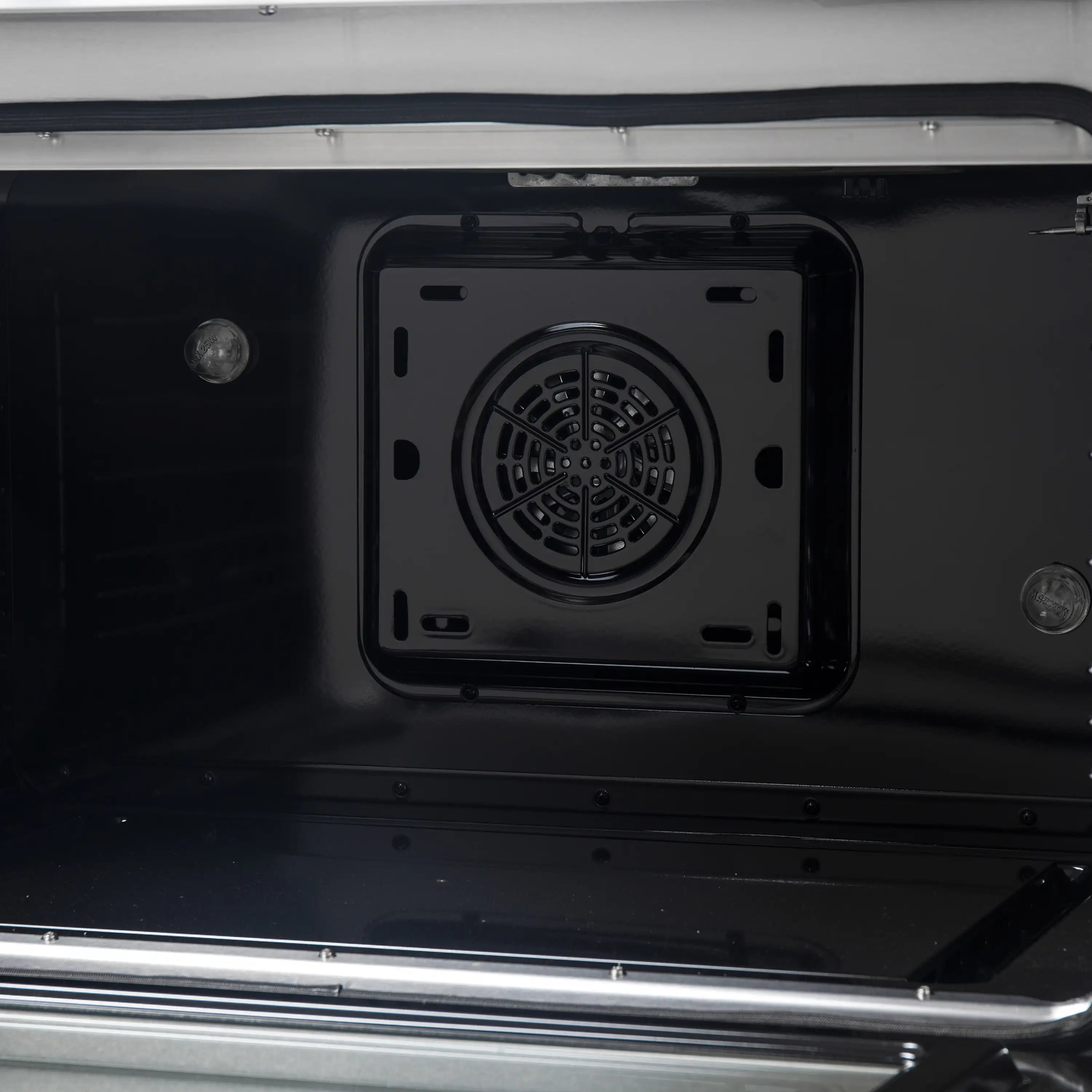 Dual fuel oven cavity with rear circular vent and side heating areas