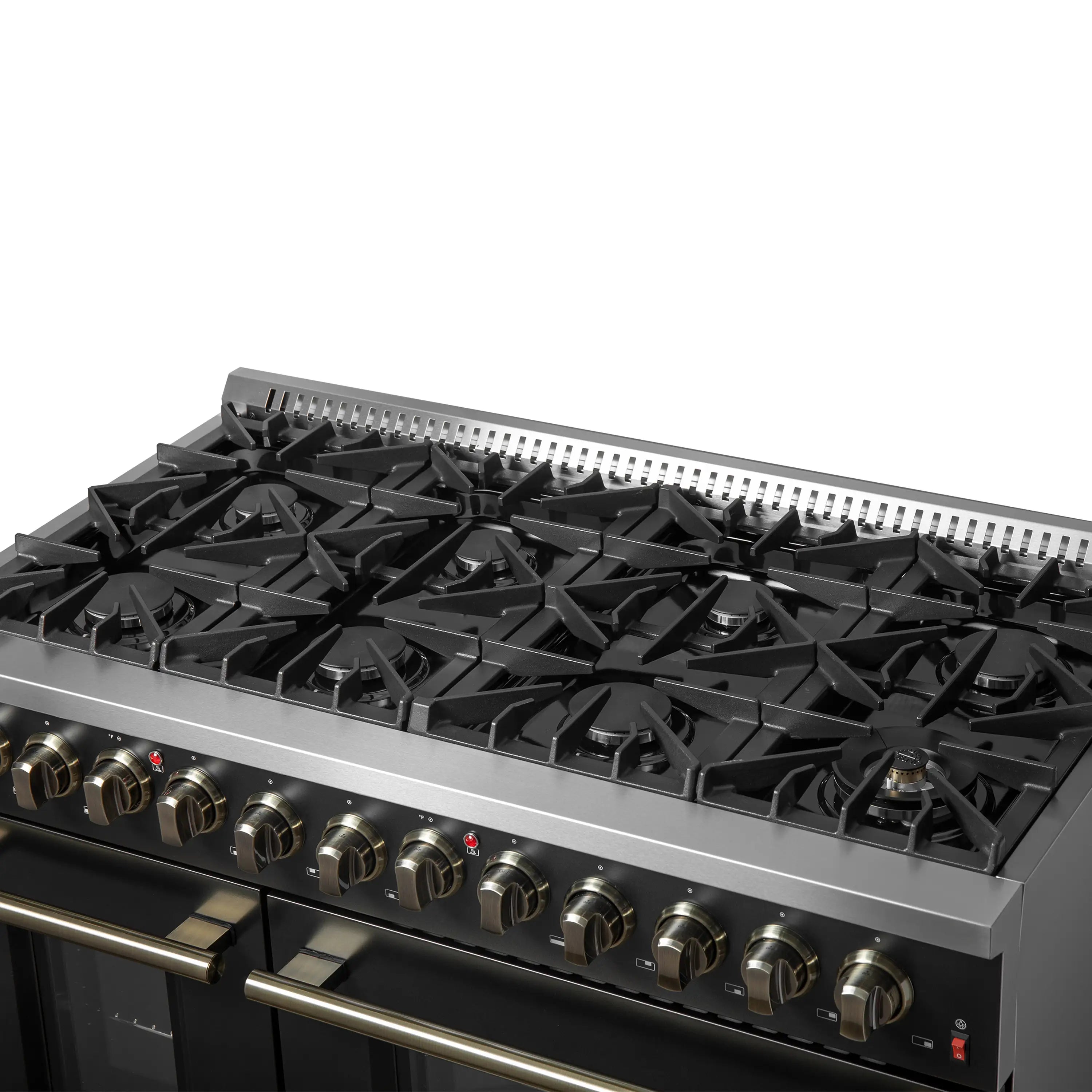Cooktop close-up of black burner grates and brass control knobs on a dual fuel range